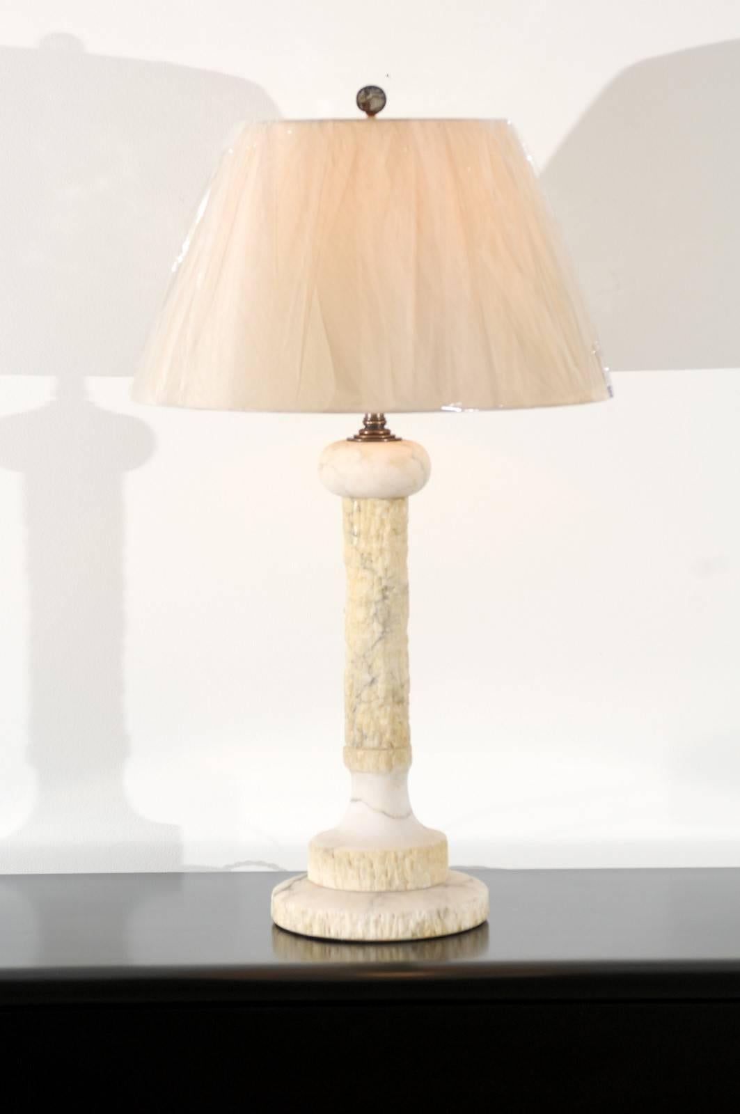 An exceptionally lovely pair of vintage modern honed marble lamps. Beautiful tree form design with fabulous texture replicating the look of tree bark. Wonderful weight and craftsmanship. While unmarked, the pieces are consistent with Italian marble
