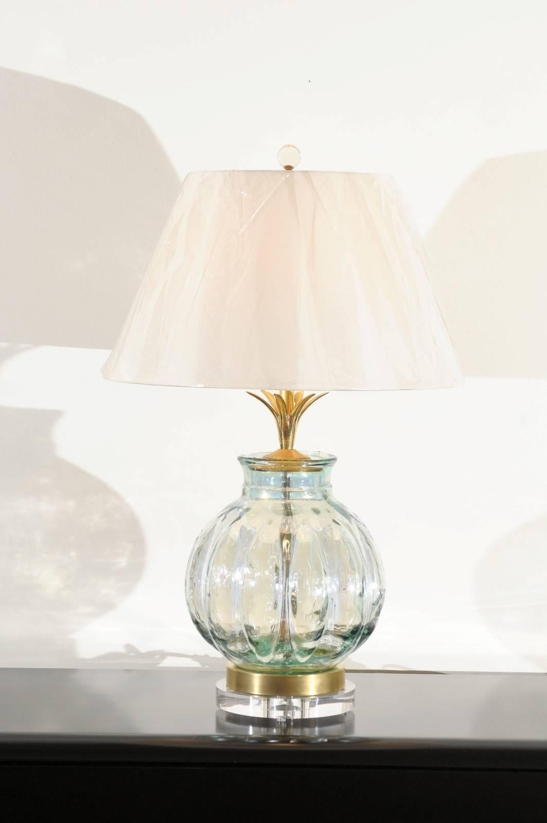 An exceptional pair of blown glass vessels as custom lamps. Thick and heavy fluted form with a subtle reflective quality. Beautiful solid brass petal neck detail and two-step base comprised of new museum quality Lucite and brass. Exquisite jewelry!