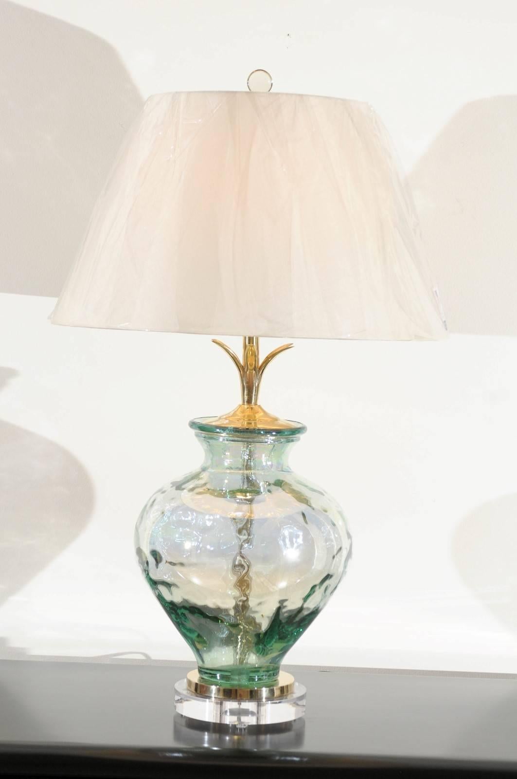 A lovely pair of heavy glass vases as custom lamps. Beautiful, thick blown glass form with a subtle reflective quality. Fabulous weight and craftsmanship. Exceptional jewelry! Excellent restored condition. Wired using clear cord; new three-way brass