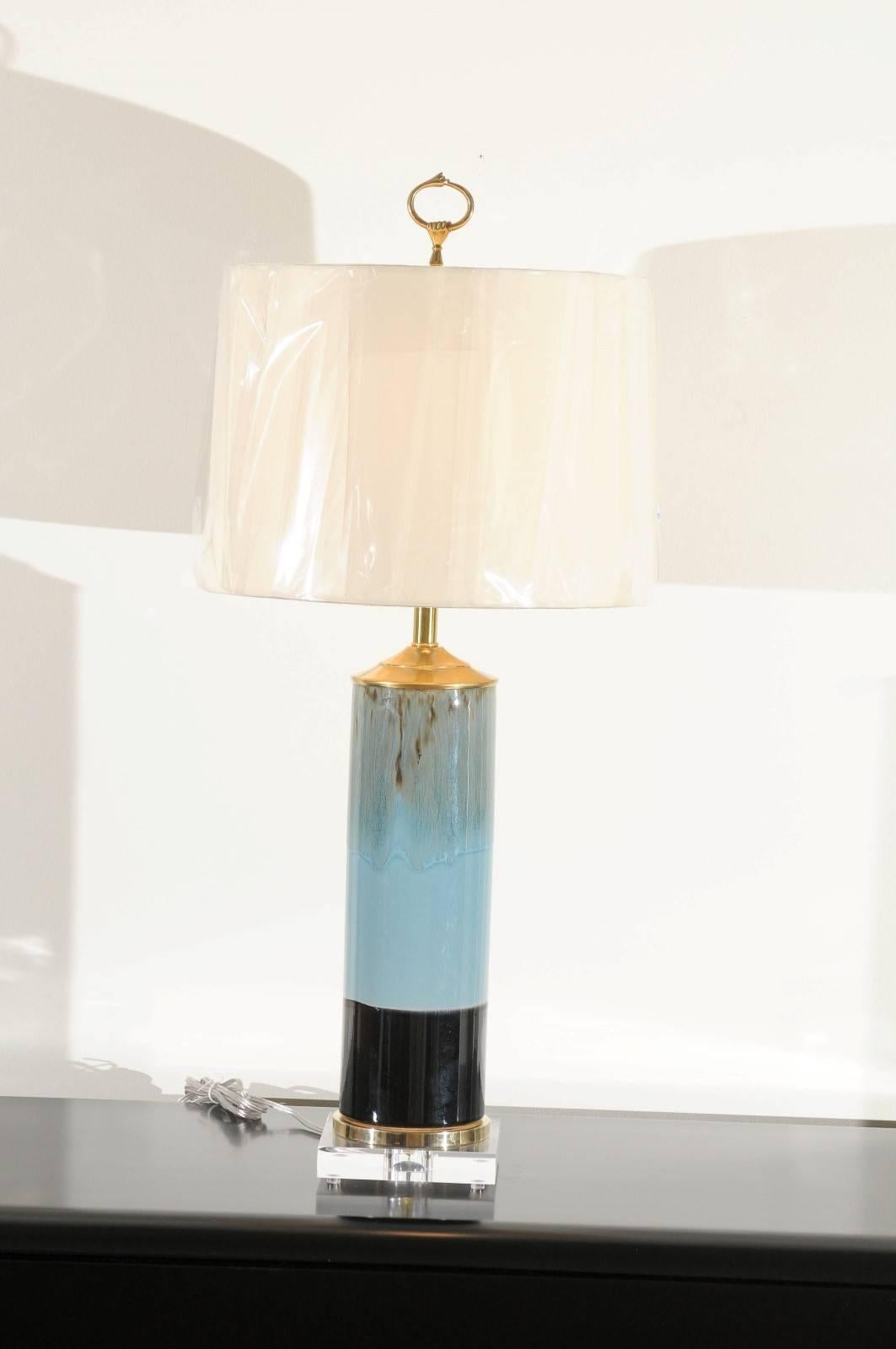 A stunning pair of ceramic vessels as custom lamps. Beautiful drip glaze cylinder form with wonderful color and sheen. Fabulous weight and craftsmanship. Exceptional jewelry! Wired using clear cord, new brass three-way sockets with brass turn