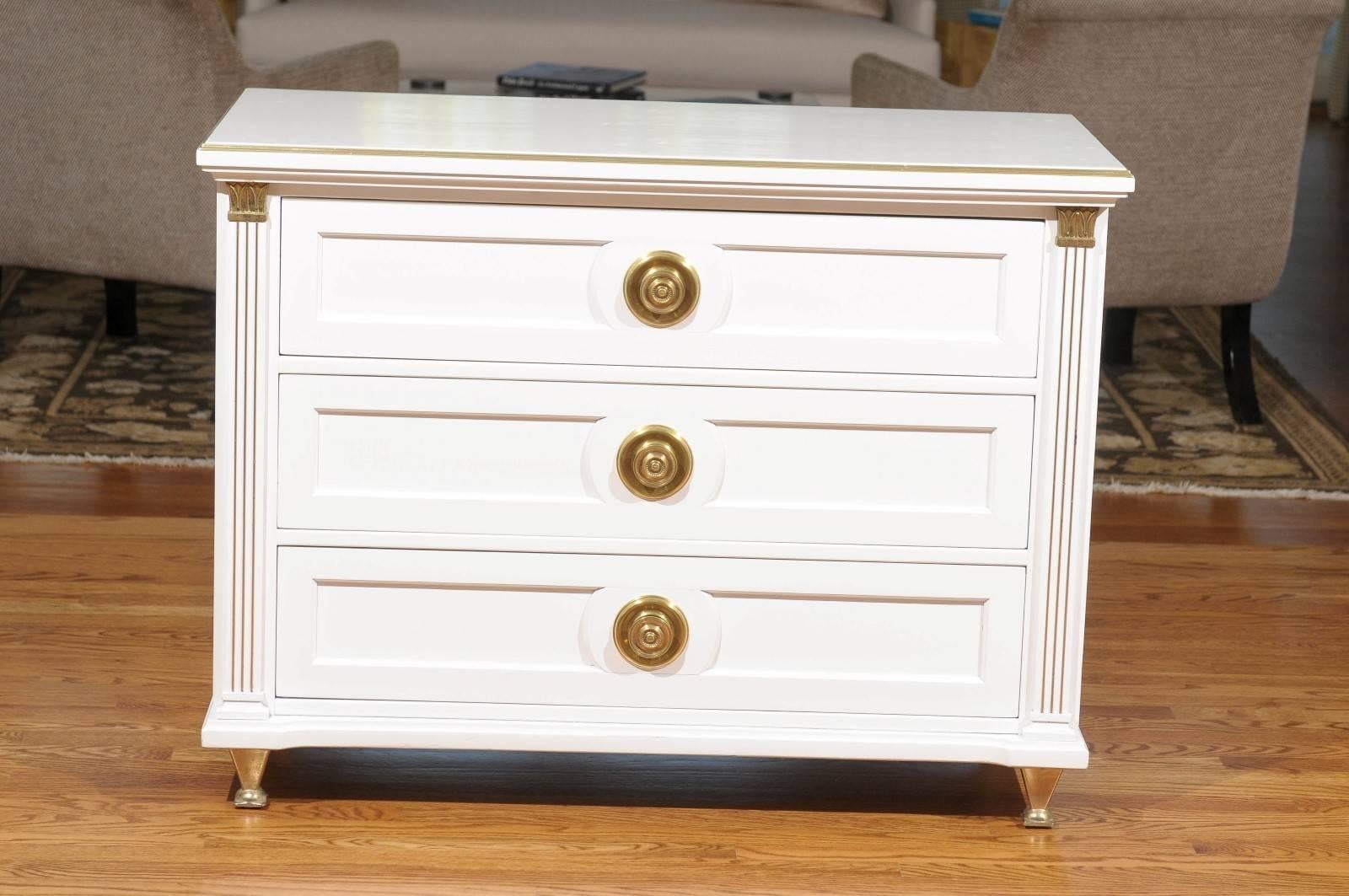 An exceptional pair three-drawer chests, circa 1960.  Stout and stunning solid mahogany case construction with painstaking detail, mounted atop killer solid brass feet.  Fabulous solid brass case highlights and drawer hardware.  Design, material