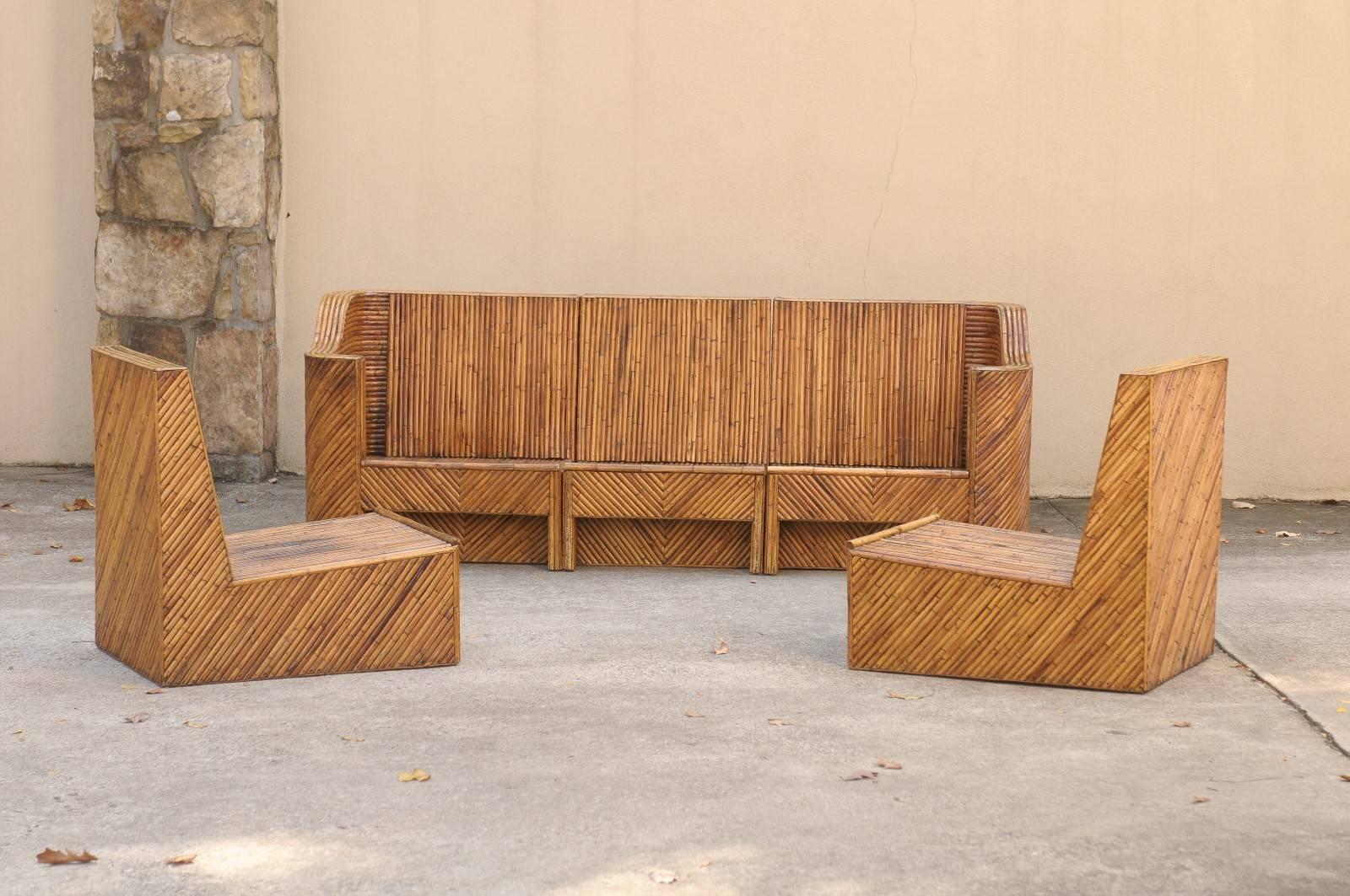 A fabulous seven-piece seating set, circa 1975. A stylish and functional set which may be used in a number of configurations. Stout and expertly constructed solid mahogany frame completely veneered in diagonally applied pencil bamboo. Exceptional