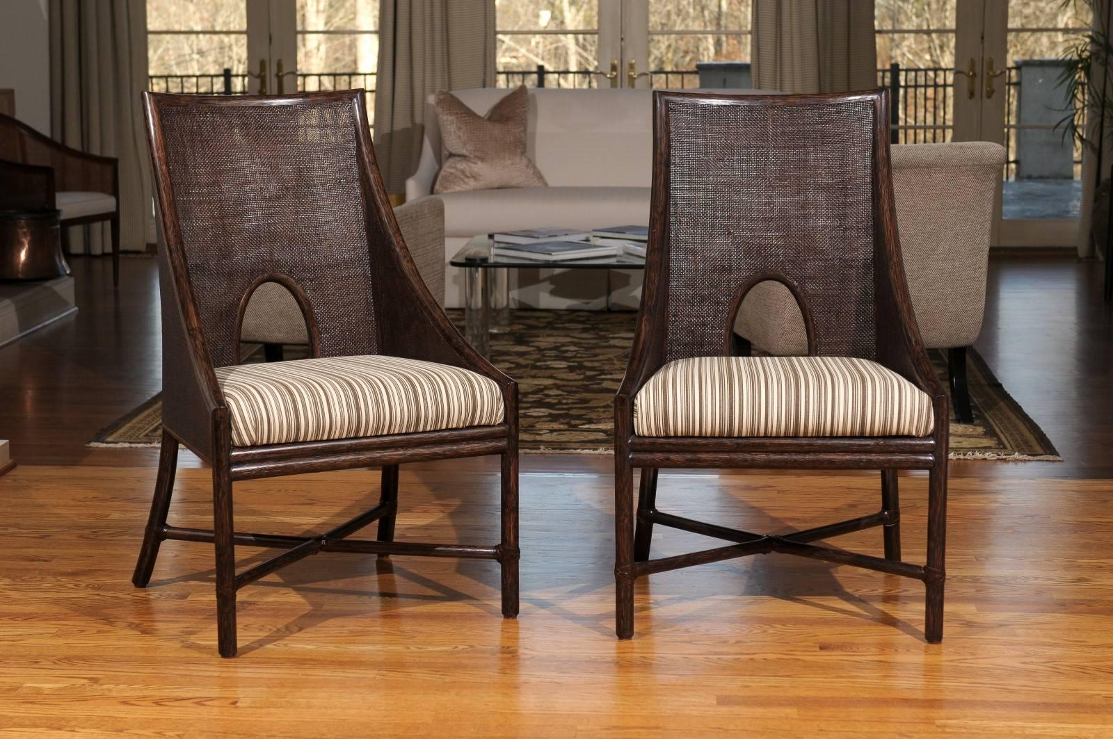 A fabulous set of six dining chairs by McGuire. Expert rattan frame construction with leather wrap joint accents; Tobacco finish. Exquisite fine cane mesh double faced back with loop detail. Stout, comfortable and suitable for heavy regular use.