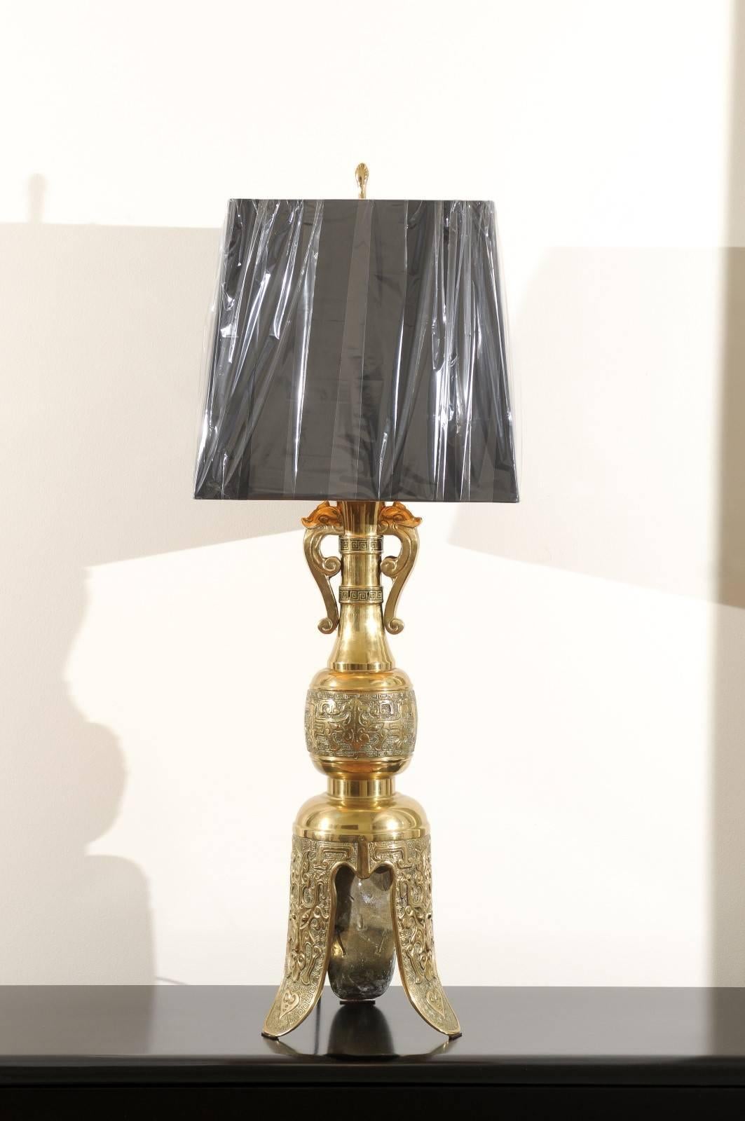 An absolutely jaw-dropping pair of large-scale vintage lamps, circa 1960. Exquisite solid brass form with stunning texture. Fabulous cast elephant heads and Greek key detail highlight the neck. The magnificent base recalls the look of an ancient