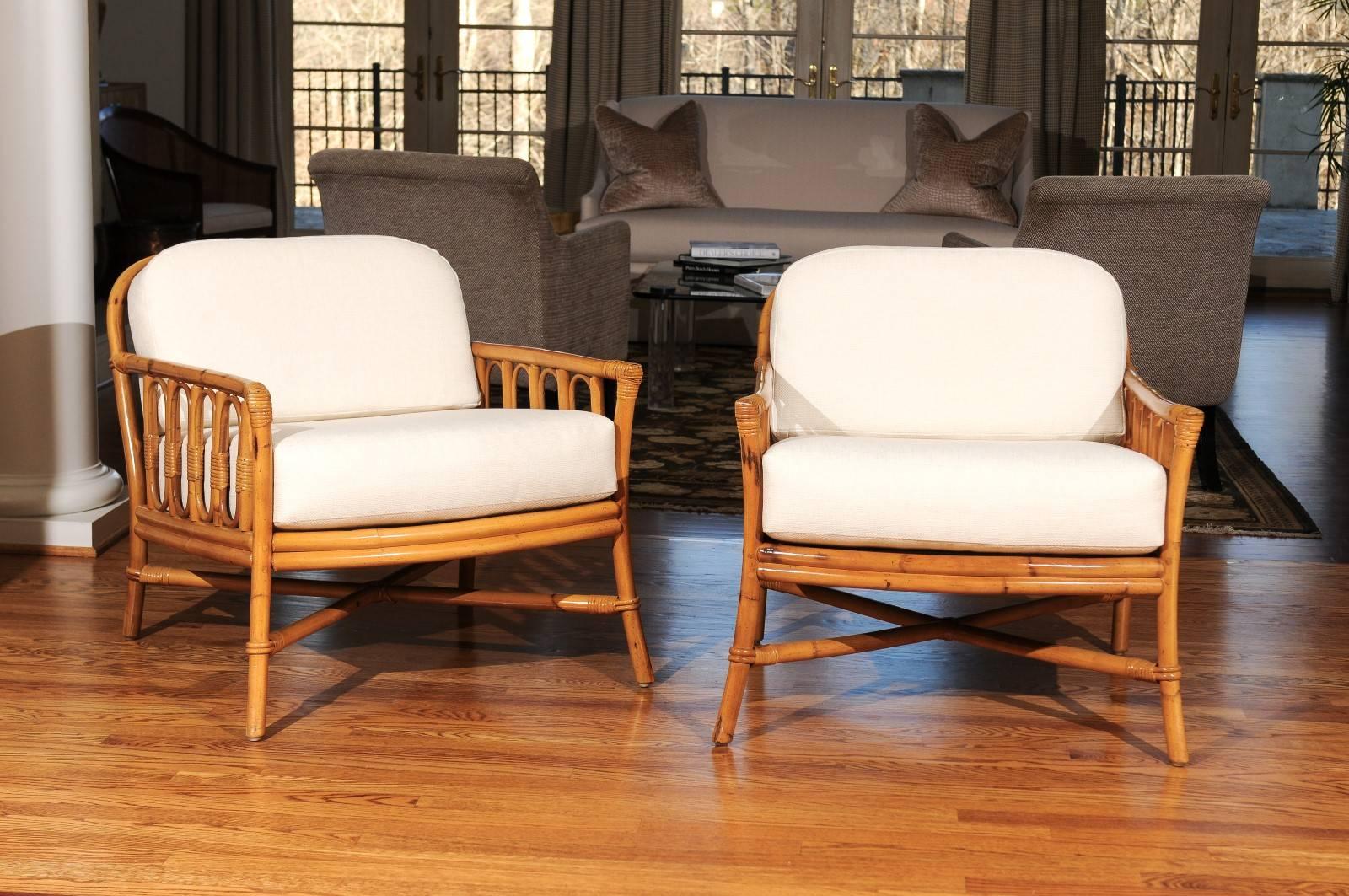 A killer pair of highly decorative rattan lounge chairs by Ficks Reed, circa 1970. Exceptional rattan and hardwood construction. Beautifully proportioned with fabulous detail. Excellent restored condition. The chairs have been professionally cleaned
