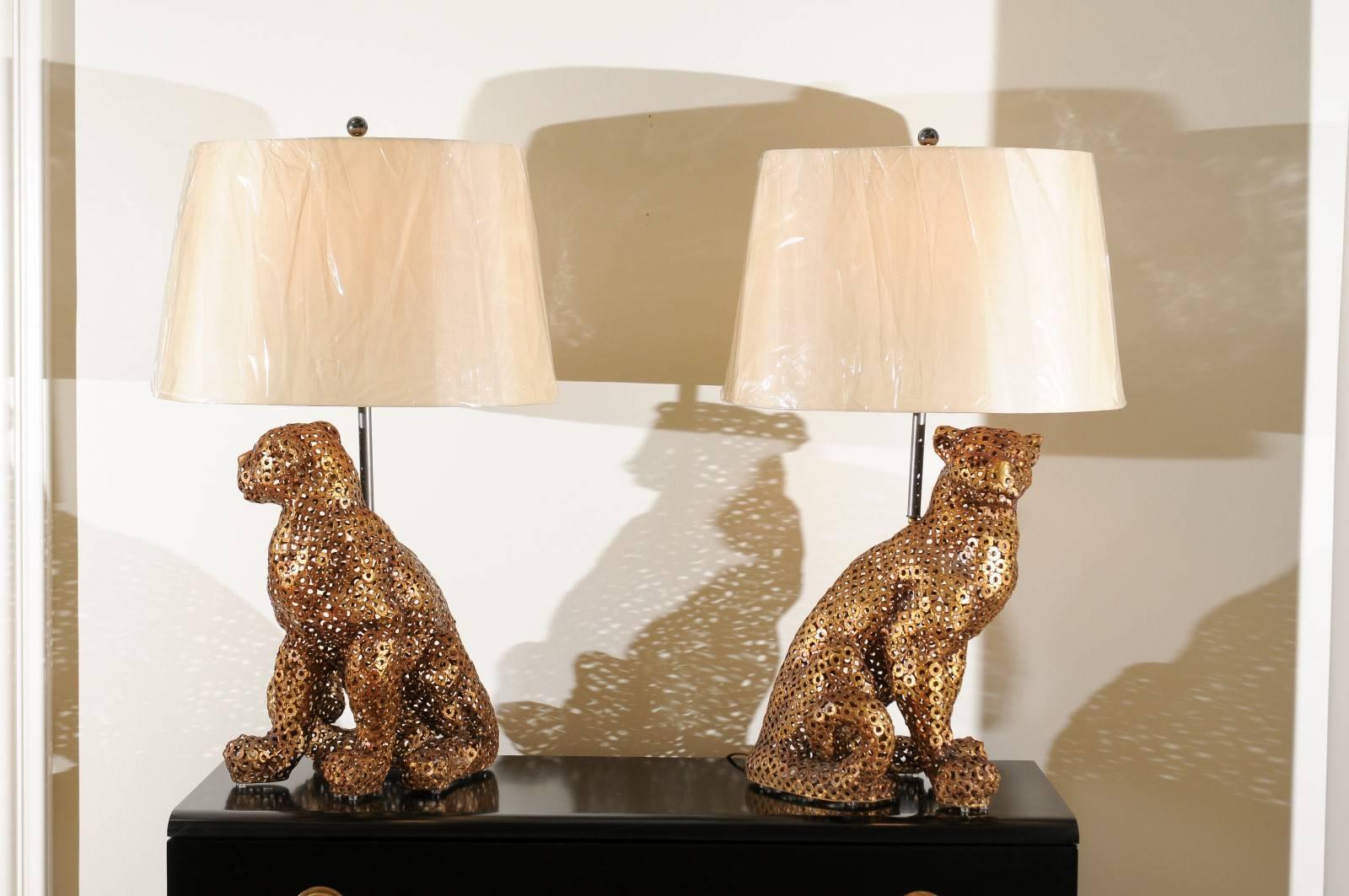 A mind-boggling pair of handmade panther sculptures as custom lamps, circa 1970. The figures are fashioned from individual common stock steel washers, painstakingly welded to form. Fabulous dull gold finish aged to absolute perfection. Exquisite