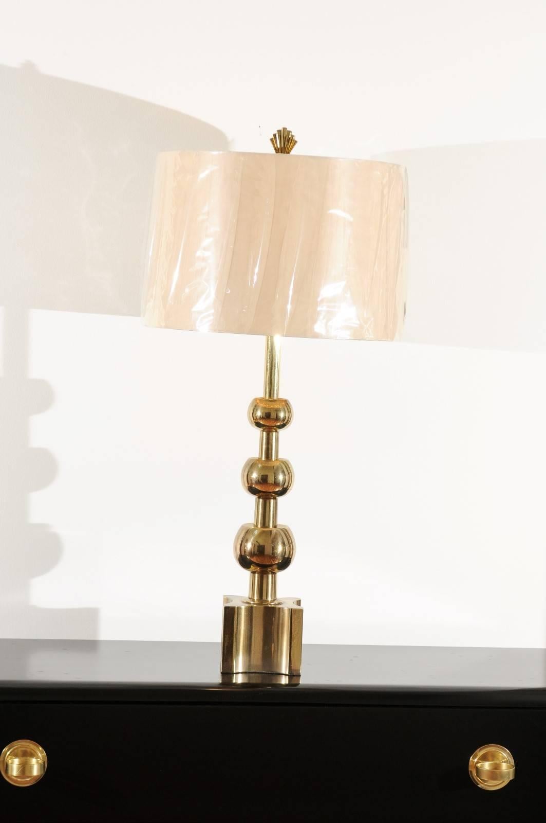 A stellar pair of large-scale brass lamps by Stiffel, circa 1960. Vertical graduated ball form atop a chunky plinth base. One of the most coveted designs in the Stiffel archive. Exquisite jewelry! Excellent restored condition. The pieces have been