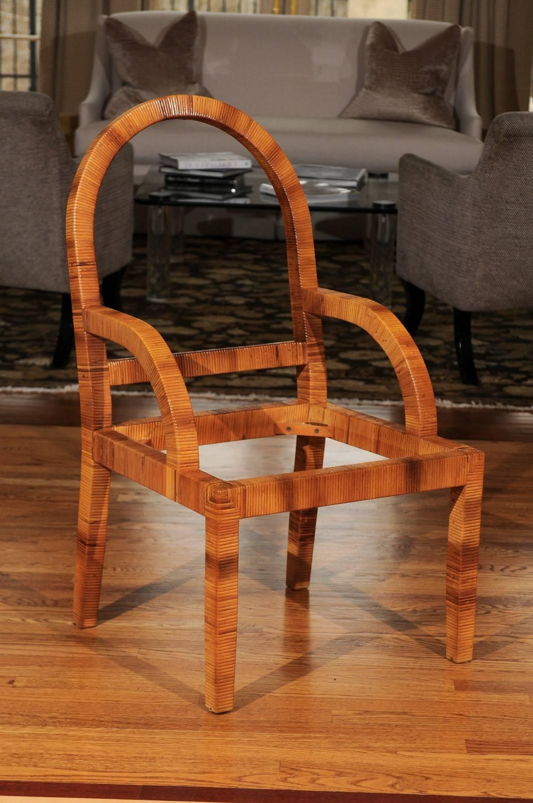 A stunning set of four armchairs by Bielecky Brothers, circa 1980. Heavy, stout solid hardwood form painstakingly hand-wrapped in cane. Exceptional quality, style and craftsmanship. May be sold as pairs. The arm height is 25 inches. Stellar jewelry!