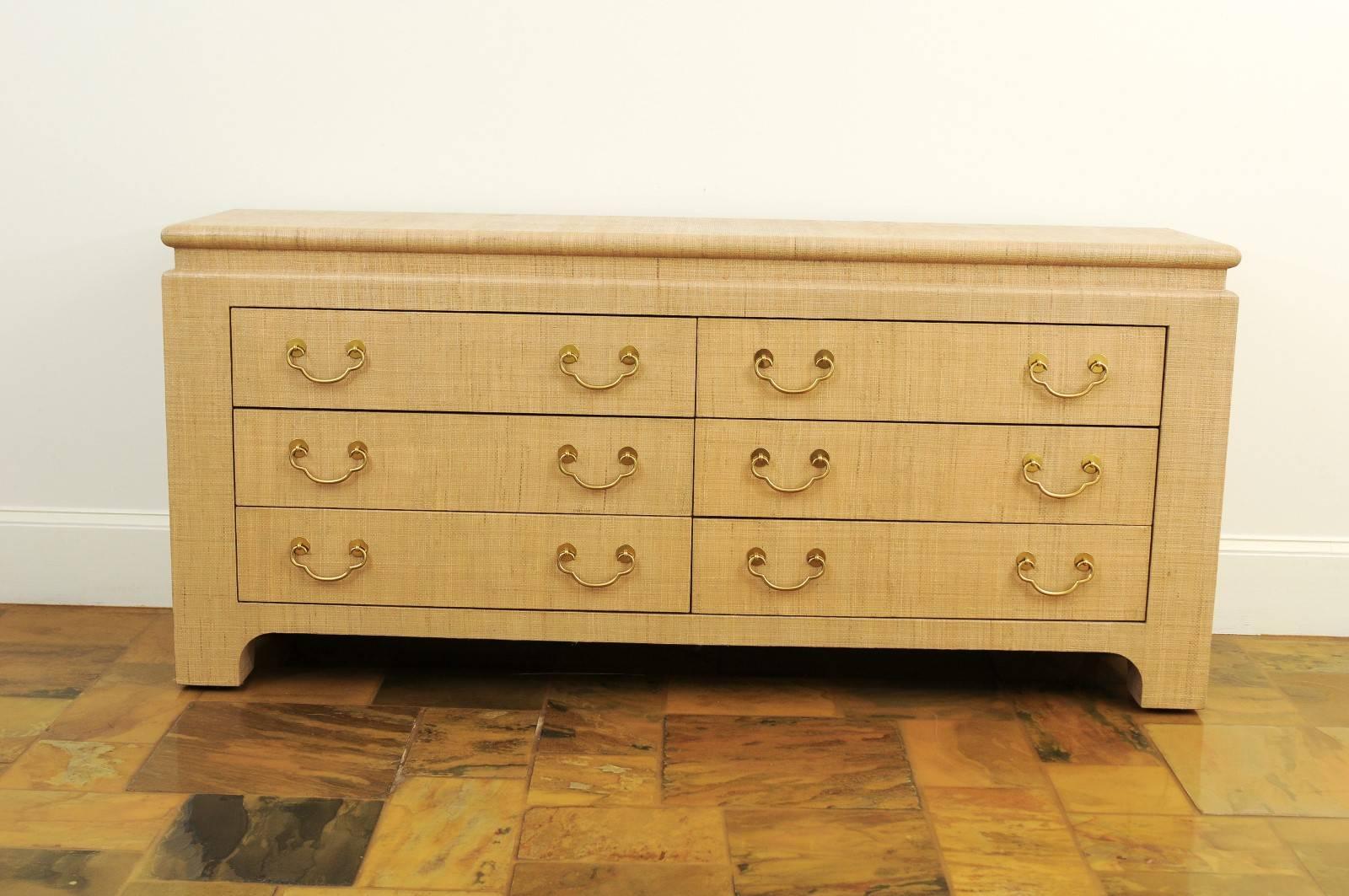 A stellar six-drawer chest from the boutique production of Harrison-Van horn, circa 1995. Exquisite case design with fabulous lines. Stylish Pagoda top detail and solid brass hardware add drama. The piece is completely veneered in natural raffia