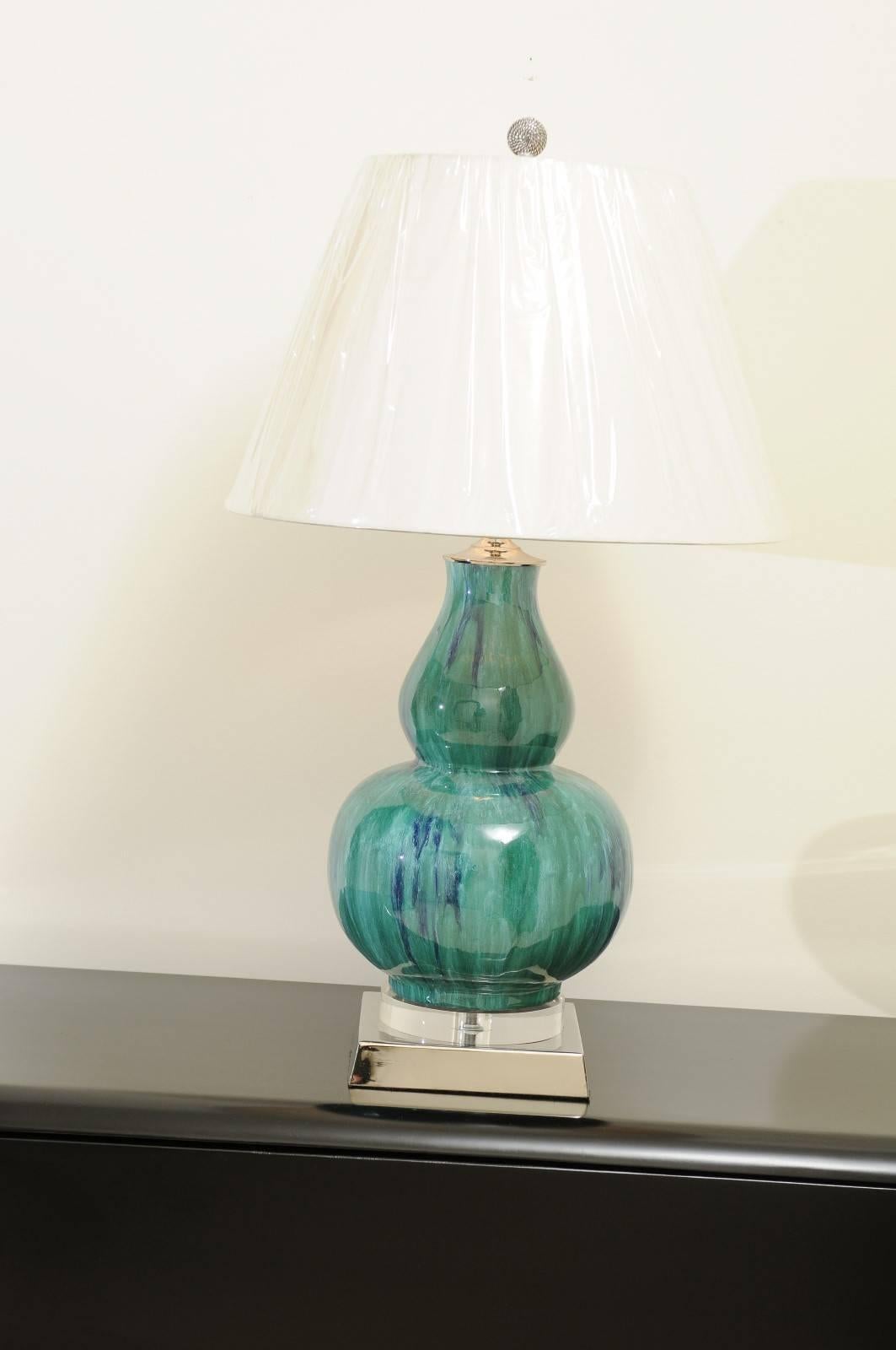 A stunning pair of drip glaze ceramic vessels as custom made lamps. Beautiful form with fabulous highlights of Turquoise, Teal and Cobalt. Accents in polished Nickel and Lucite. Expertly crafted using components of only the finest quality. Exquisite