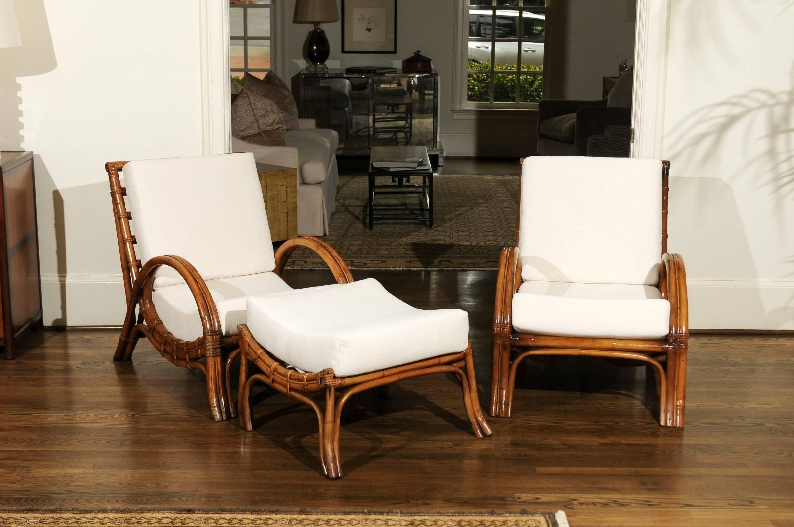 An exquisite pair of lounge chairs with matching ottoman by the Calif-asia company, circa 1960. Beautifully crafted rattan construction with fabulous style and attention to detail. Stout, sturdy, comfortable and suitable for heavy regular use. This