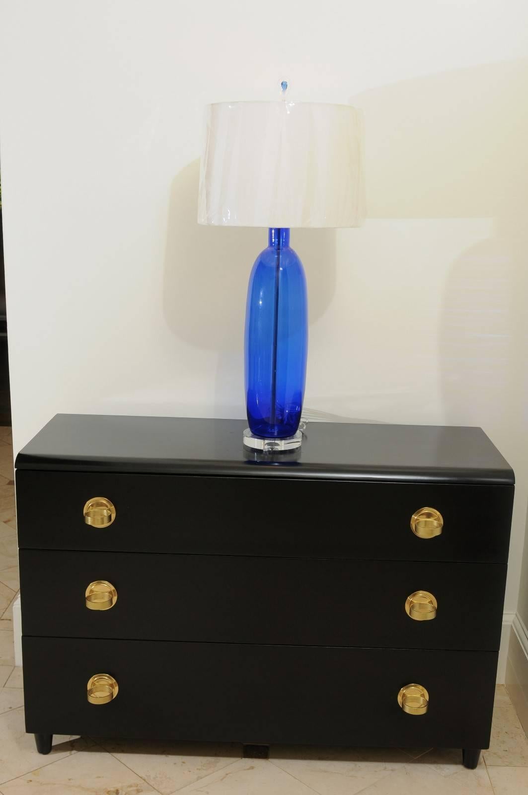 A stunning pair of large-scale blown glass lamps, circa 1970. Beautiful shape and form in a staggering Cobalt color. Lovely blown glass finials ice the cake. Restored using components of only the finest quality. Exceptional jewelry! Excellent