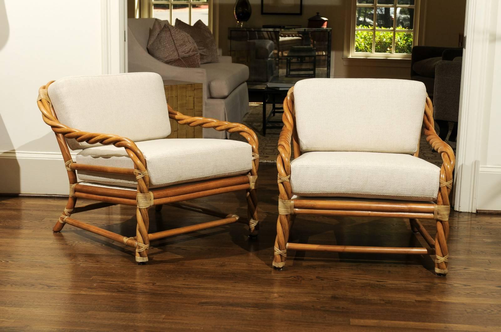 A beautiful pair of loungers from a difficult to find series by McGuire, circa 1980. Clever braided rattan design with binding accents in rawhide. Painstakingly crafted with superb attention to detail. This particular design is coveted by McGuire