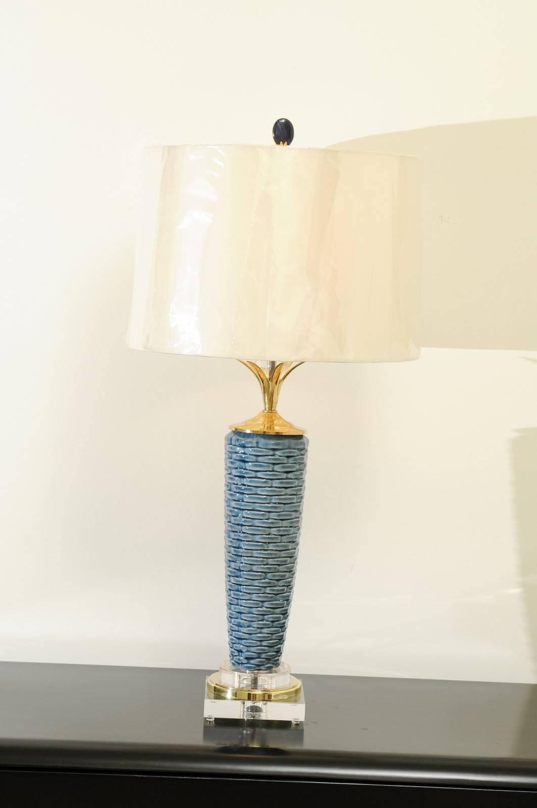 A lovely pair of handmade ceramic vessels as custom lamps. Striking tornado form with a textured basketweave design. Beautiful brass flower petal neck detail with a Lucite orb. Lucite and brass accents. Built using components of only the finest