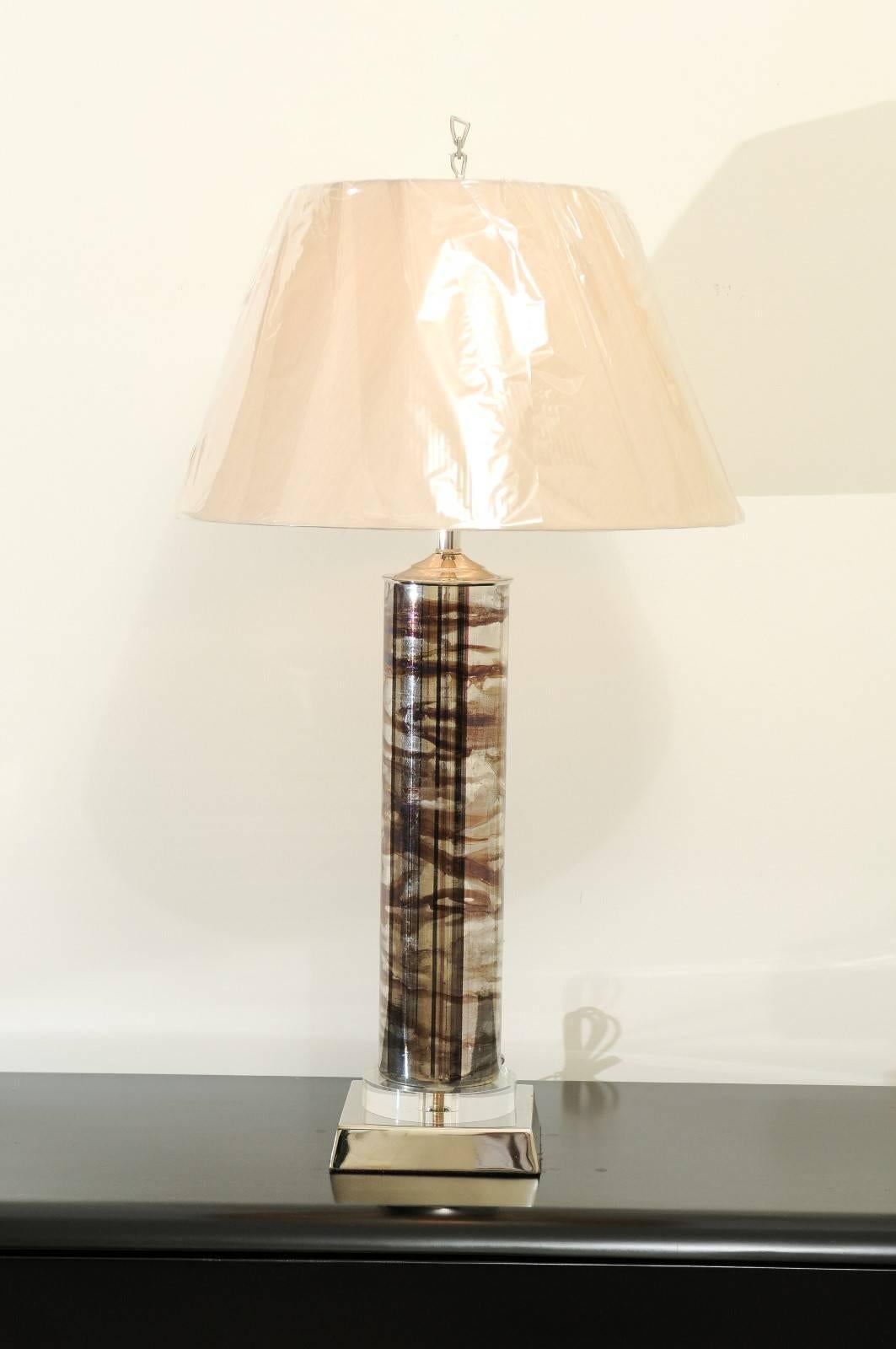 A stunning pair of blown glass lamps, circa 1970. Sleek cylinder from with reverse paint in silver and chocolate. Restored using components of only the finest quality. Wonderful detail and quality. Exceptional jewelry! Excellent Restored Condition.