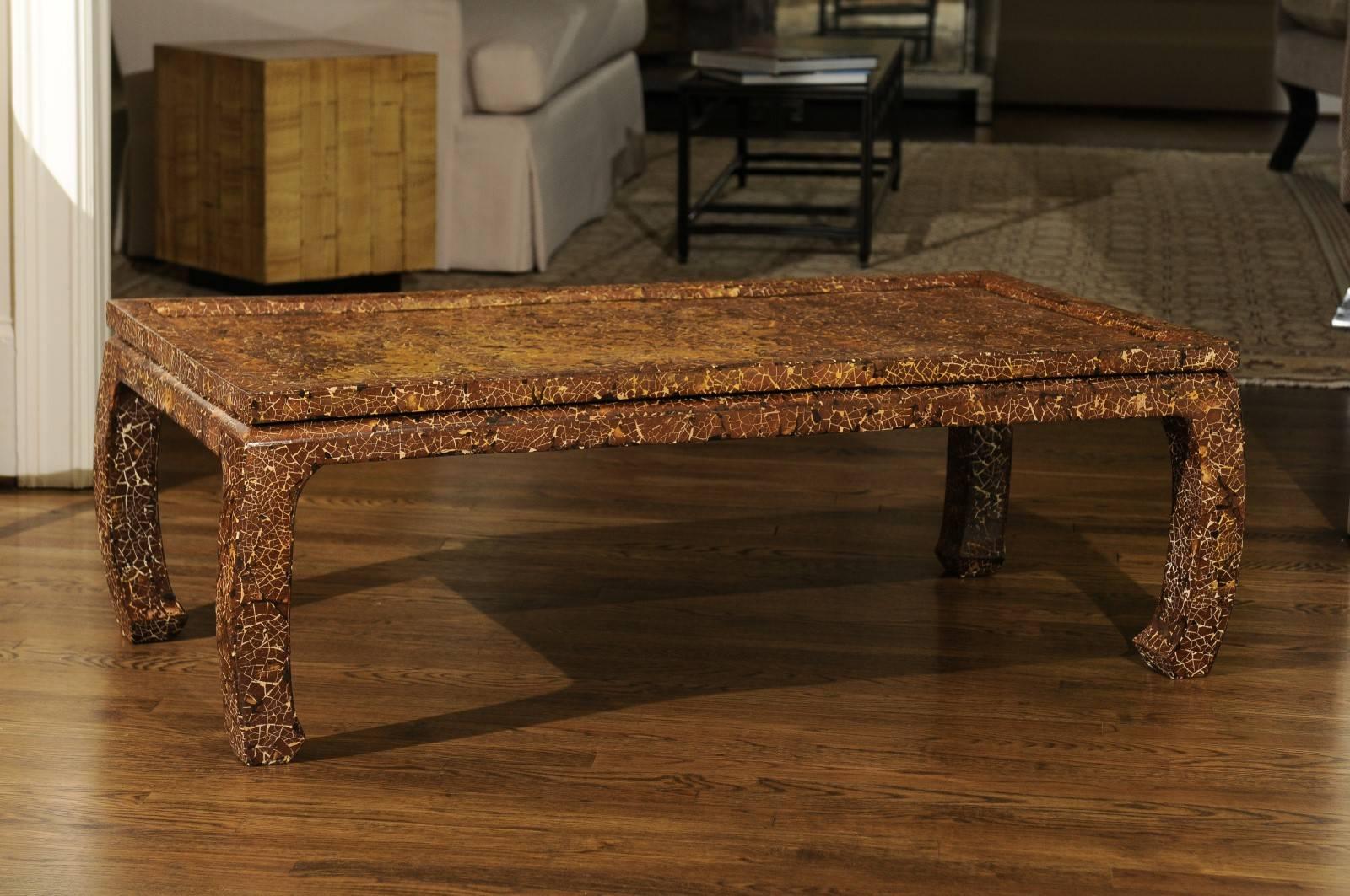A stunning custom coffee table, circa 1985. Heavy, expertly crafted Mahogany construction with lovely Asian detail. A fabulous array of thick lacquer colors form a crackled mosaic finish. An exceptional piece of jewelry! While the table is unmarked,