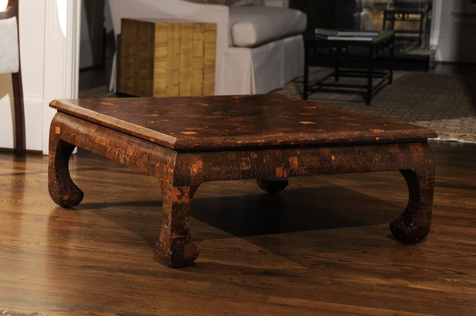 A stunning restored organic coffee table, circa 1980.  Heavy, expertly crafted solid Mahogany form veneered in Coconut shell and sealed in a lacquer finish.  A piece specifically designed to anchor an important space.  While unmarked, the table is