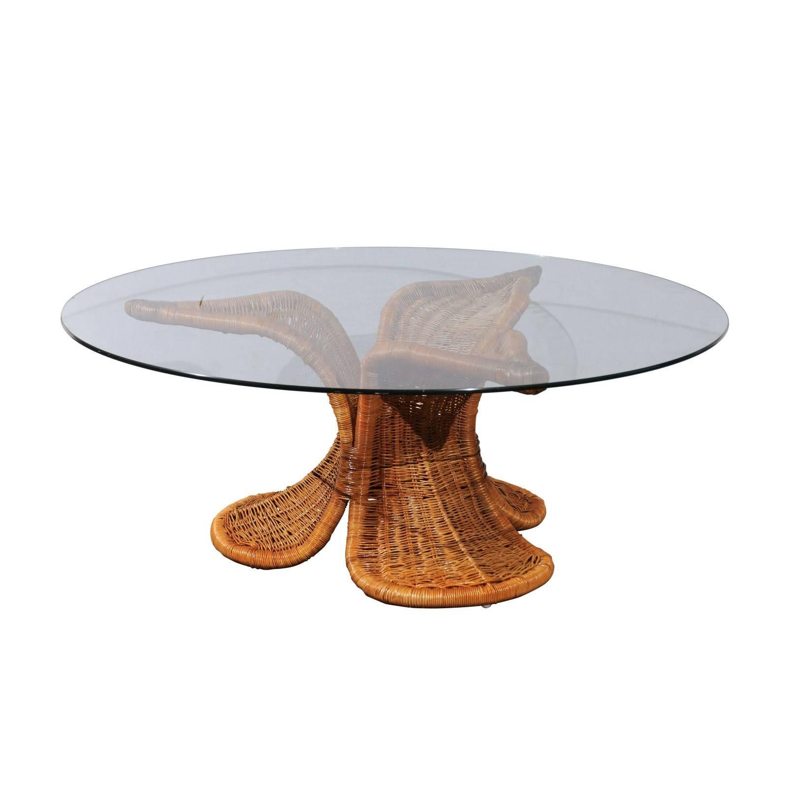 A stunning Lotus style coffee table, circa 1975. Stout metal frame painstakingly wrapped in wicker. Exceptional design and quality aged to absolute perfection. The base is designed to support a much larger and heavier piece of glass, if a larger
