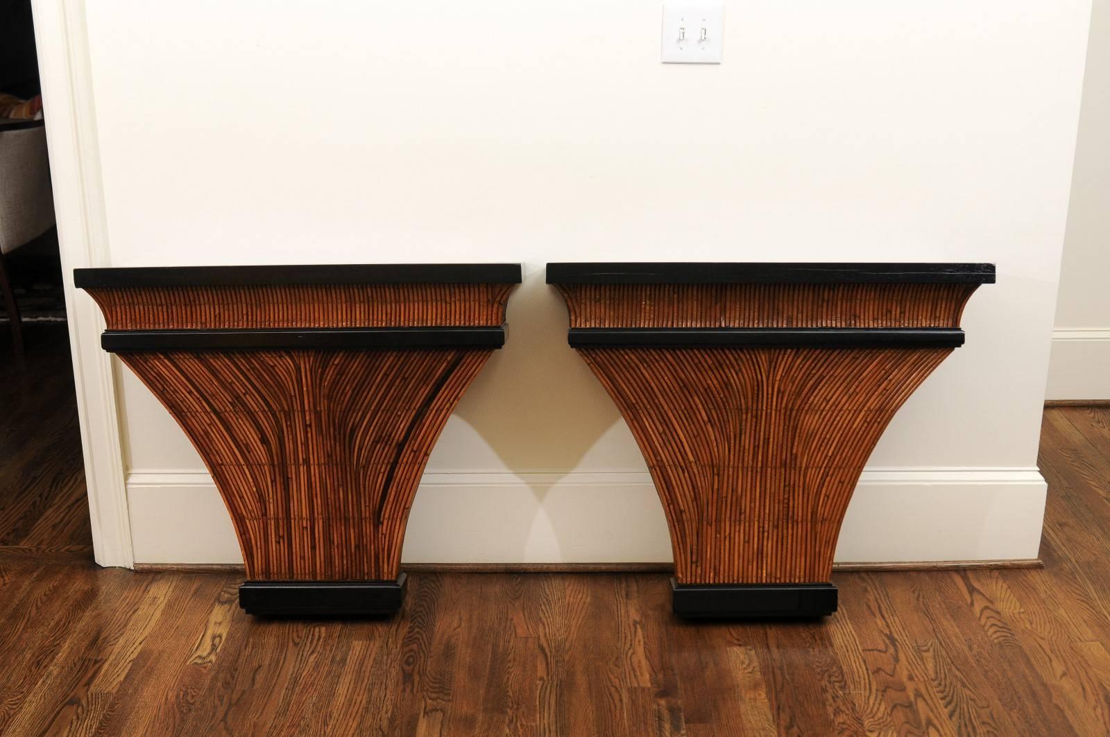 A stellar pair of bamboo consoles, circa 1975. Fabulous hardwood form veneered in reed bamboo with accents in black lacquer. The bookmatched burl elm tops are finished in a walnut stain. Exquisite design, craftsmanship and quality - aged to absolute