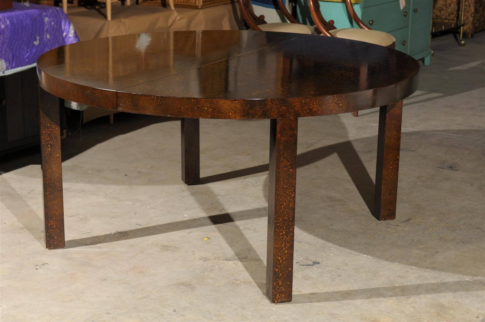 A fabulous vintage Parsons style dining table, circa 1970.  Oil drop lacquer finish which replicates the look of Tortoise Shell.  Heavy and beautifully made.  This table may be separated and easily modified to use as a dramatic pair of console