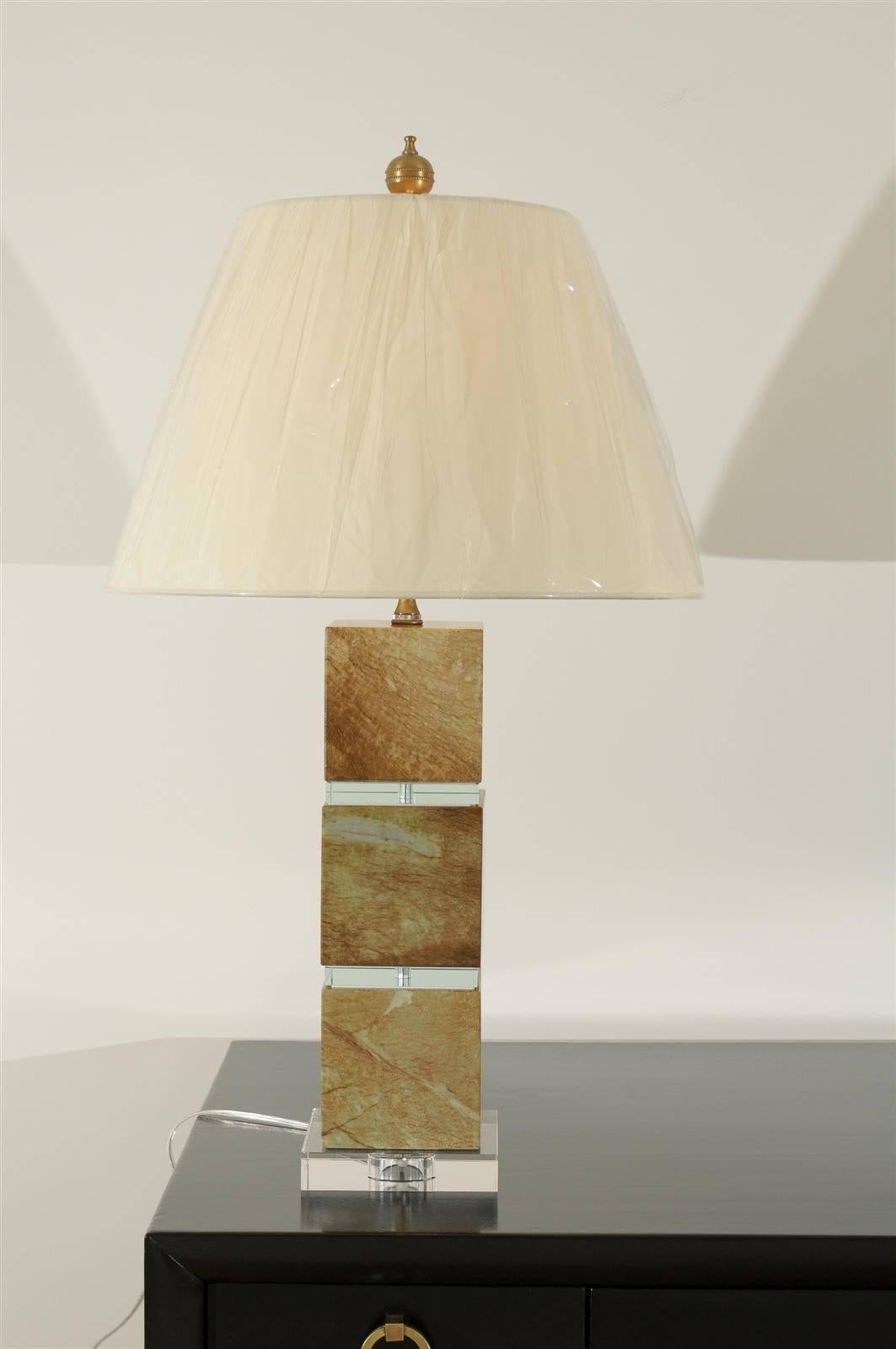 A fabulous pair of vintage lamps in Jade, circa 1980s. Solid sections of stone separated by glass plates. Heavy, beautifully made pieces. Exquisite jewelry! Excellent restored condition. The lamps have been rewired using clear cord, new three-way