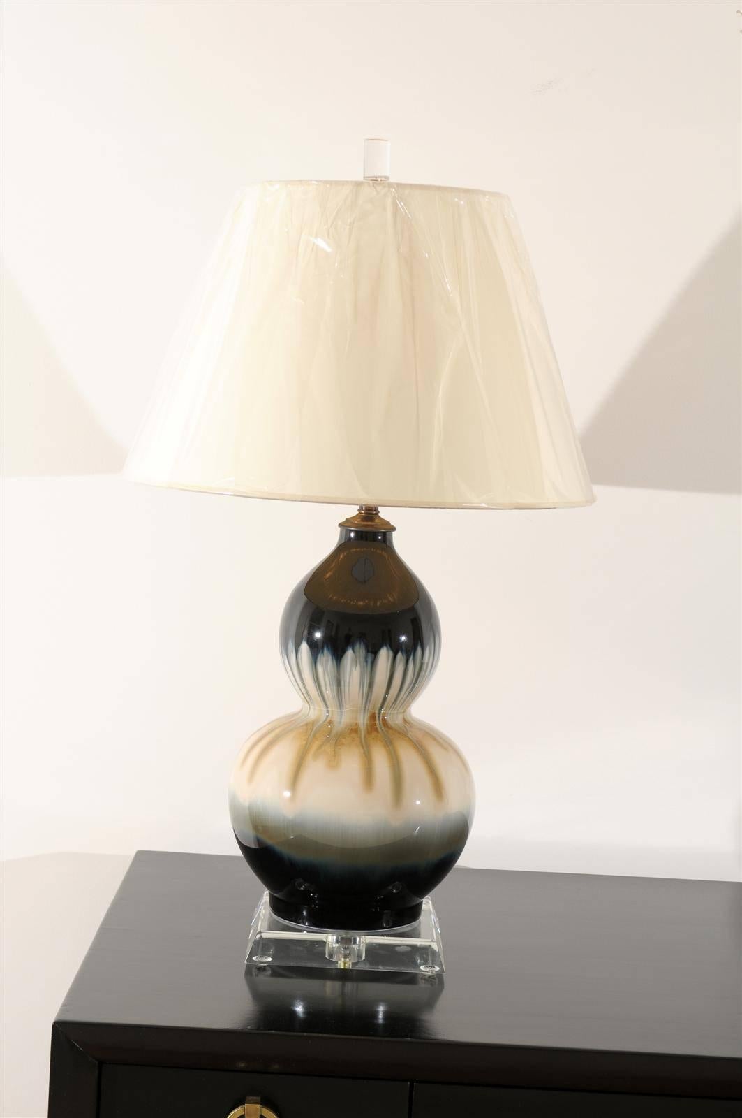 A stunning pair of vintage drip glaze ceramic double gourd lamps, circa 1980s. Exceptional range of color and finish. Sublime jewelry for any room. Excellent restored condition. The lamps have been rewired using clear cord, new three-way sockets