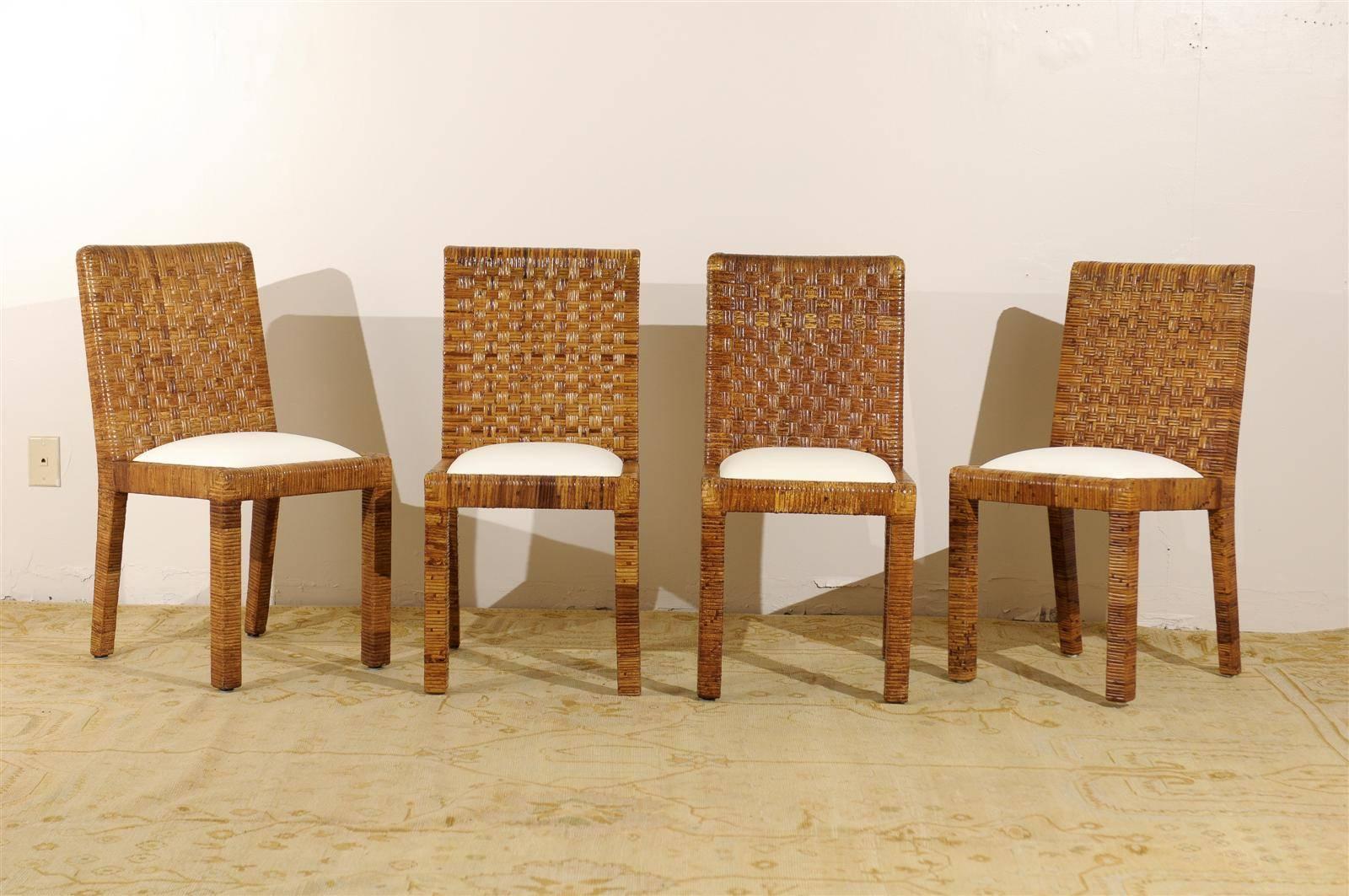 A stunning set of eight (8) Parsons style rattan dining chairs by Bielecky Brothers, circa 1970s. Stout hardwood frame construction completely wrapped in rattan. Fabulous quality and craftsmanship. The unmistakable look of Old Money ! There is