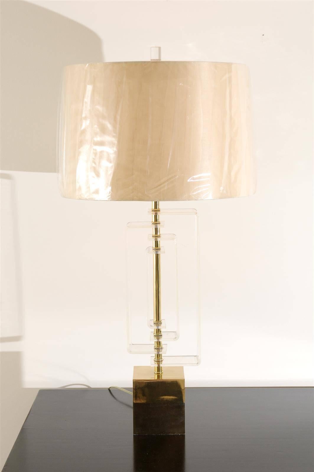 A fabulous pair of large-scale Lucite and brass lamps by Laurel, circa 1970. Individual pieces of Lucite forming a geometric motif, on a cast brass plinth with brass accents. Stunning jewelry! Excellent restored condition. All brass components have
