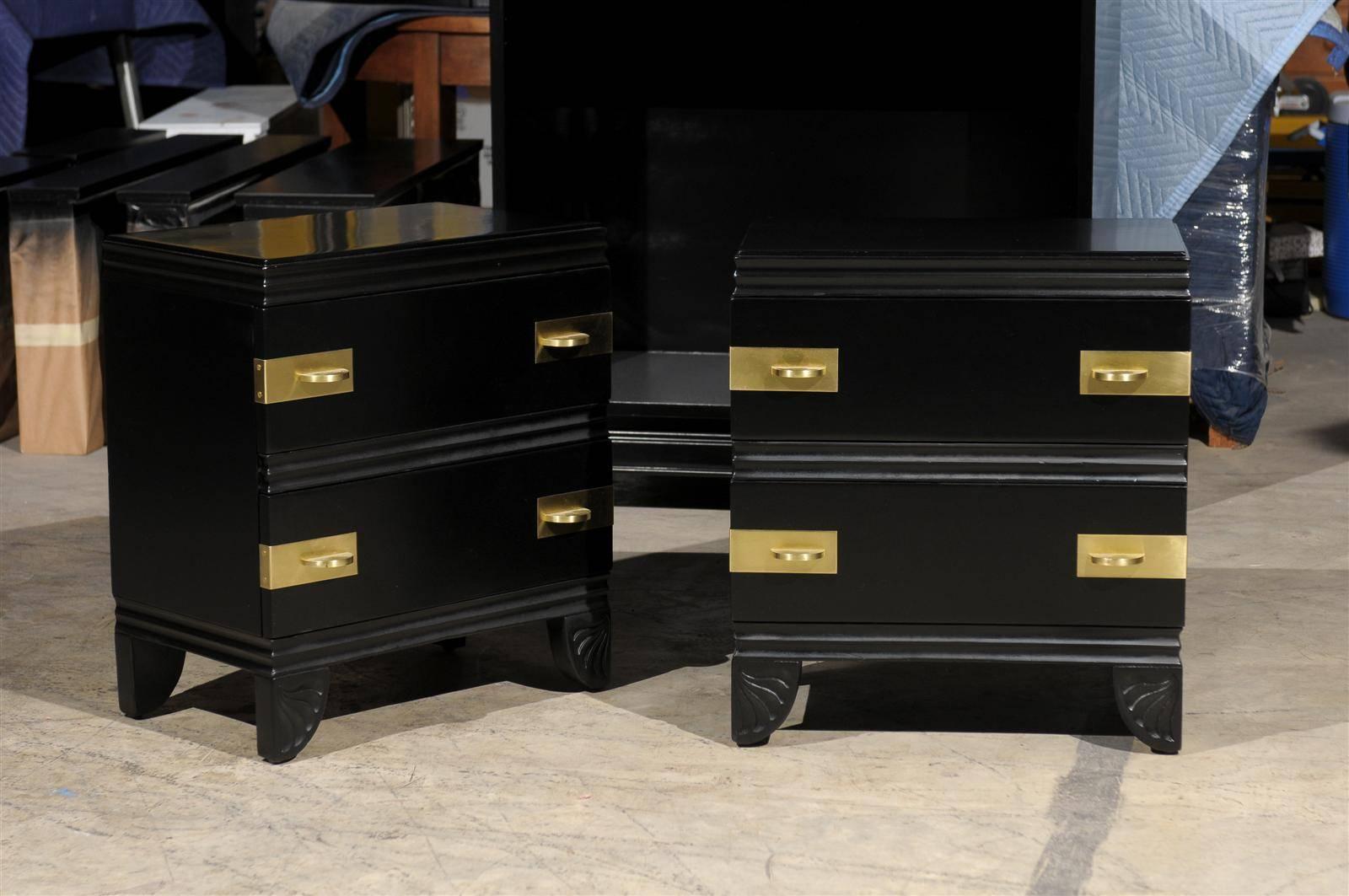 An exquisite pair of end tables or nightstands from a difficult to find case series (1110) by Widdicomb, introduced in 1938. Expertly crafted mahogany construction and restored in black lacquer. Stunning solid brass hardware marks the drawers.