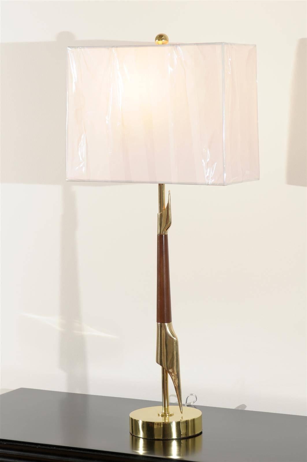 An exquisite pair of lamps from a difficult to find series by Rembrandt, circa 1960. A tall, elegant modern design executed in walnut and brass. Fabulous Jewelry! Excellent restored condition. Rewired using clear cord, new brass three-way sockets