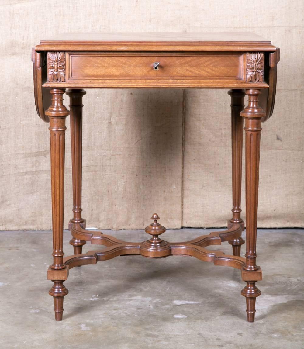 Lovely Louis XVI style drop-leaf side table with fine hand carving in solid French walnut. Parquet top with demilune leaves on each end above an apron featuring corner rosettes and a single drawer. Raised on classic tapered, fluted legs joined by an