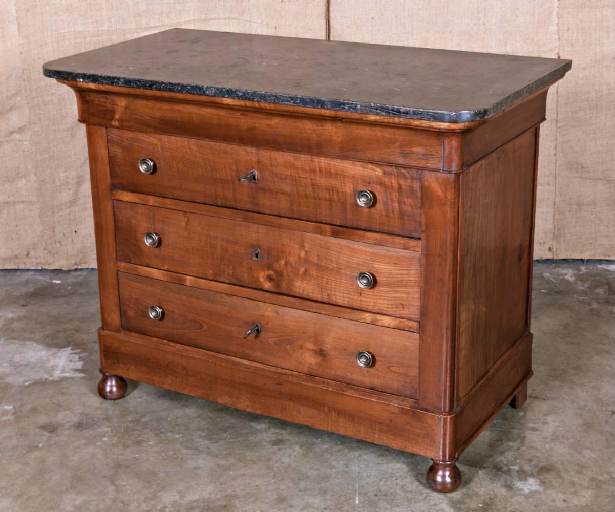 Wonderfully patinaed 19th century commode handcrafted of solid cherrywood during the French Restauration period (transition era from the First Empire of Napoleon and his replacement by Louis XVIII, who ruled as King of France from 1814 to 1824