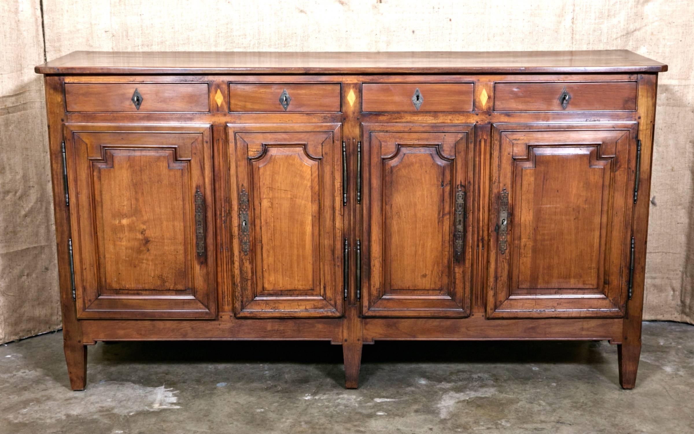 Charming 19th century French Louis XVI style cherrywood and fruitwood inlaid enfilade buffet, having four drawers with ormolu keyhole escutcheons over four paneled doors with decorative escutcheons. This extremely attractive enfilade with its