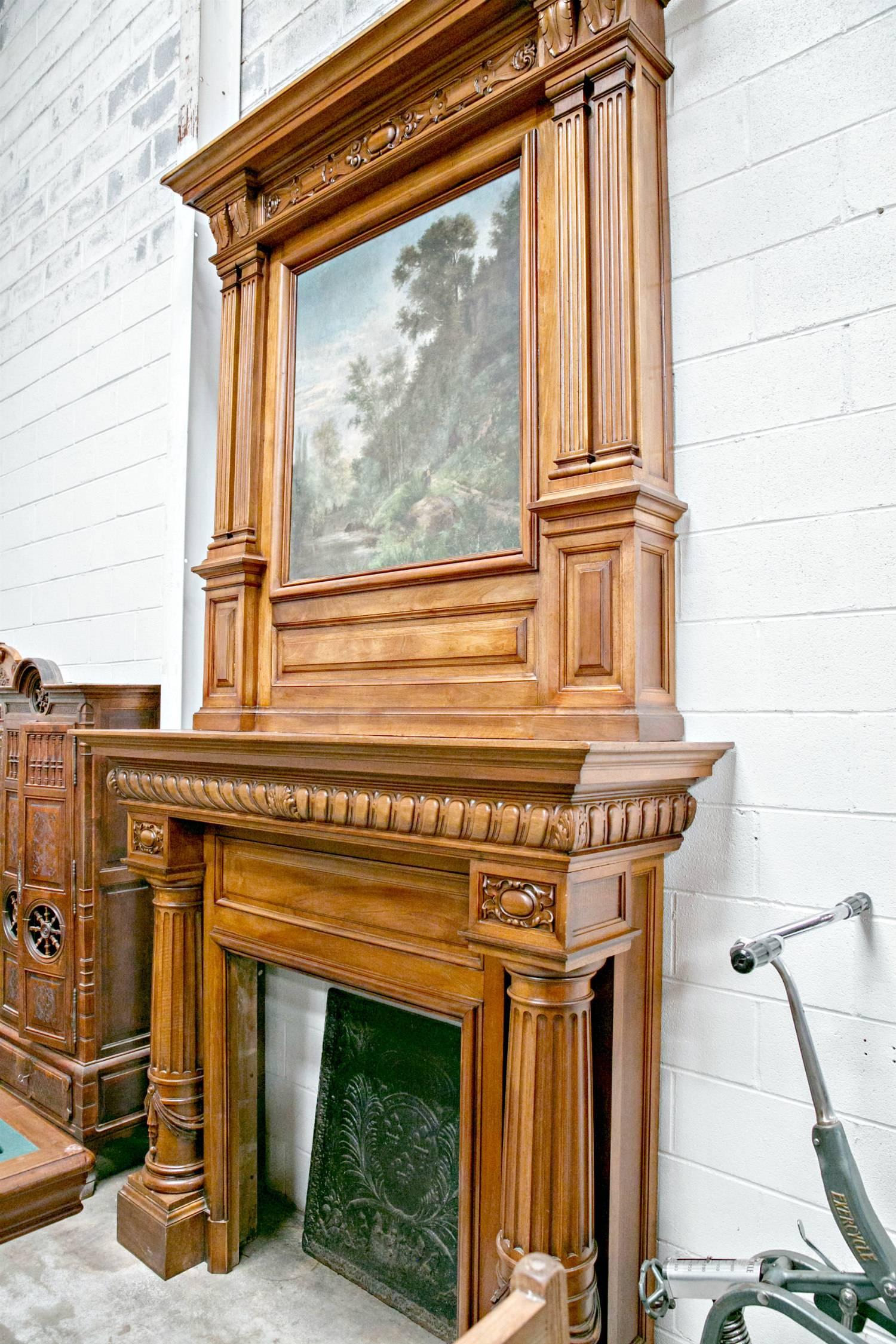 A fine monumental French chimneypiece and trumeau overmantel in the Renaissance Revival style. The masterfully hand-carved fireplace is of solid French walnut and dates from the late 19th century when it was custom built for a chateau in the