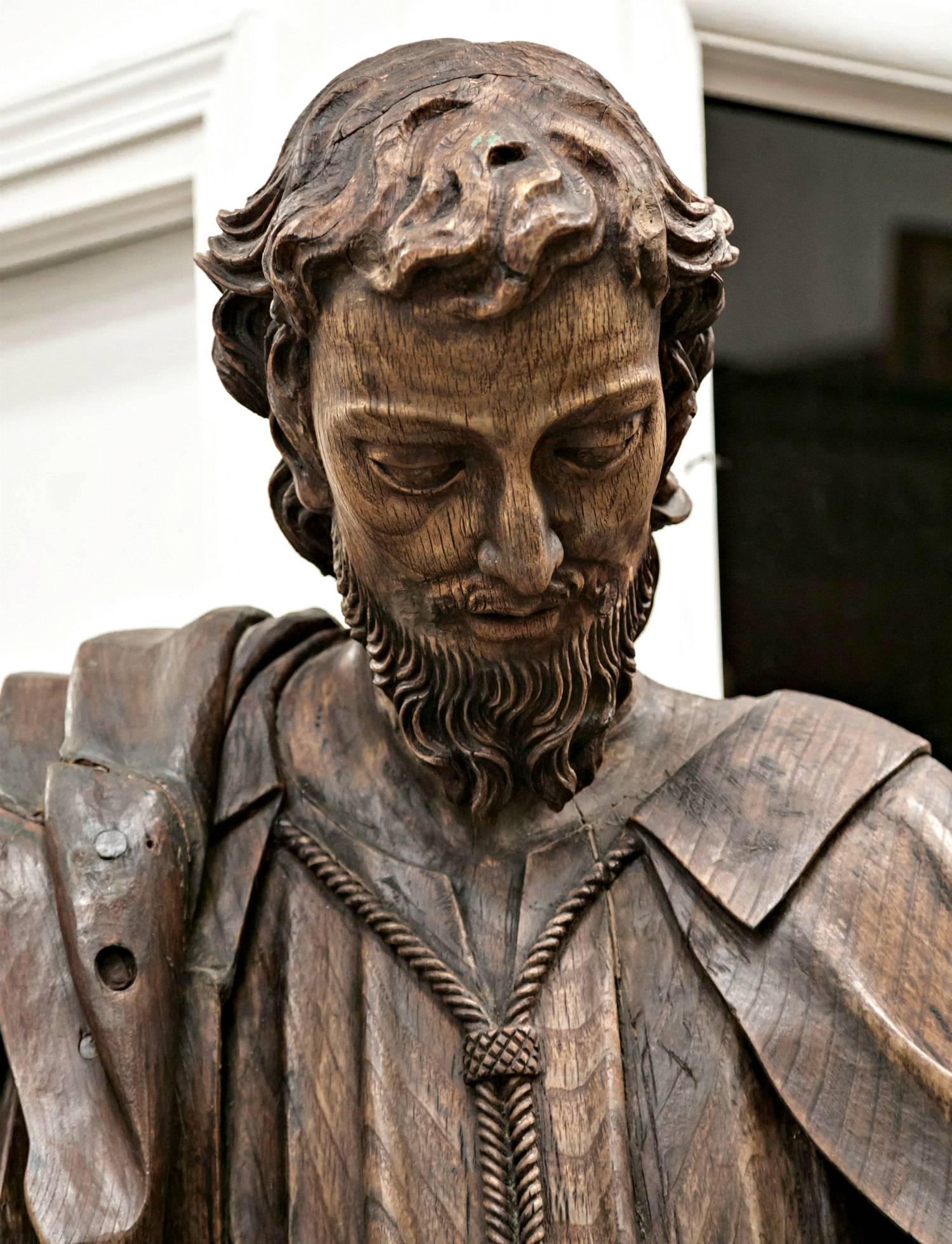 Magnificent wood statue of St. Joseph, hand-carved of solid oak with intricate draped cloths and a beautiful, lifelike facial expression. A rare and exquisite work of 18th century religious art, this life-size statue comes from a small village