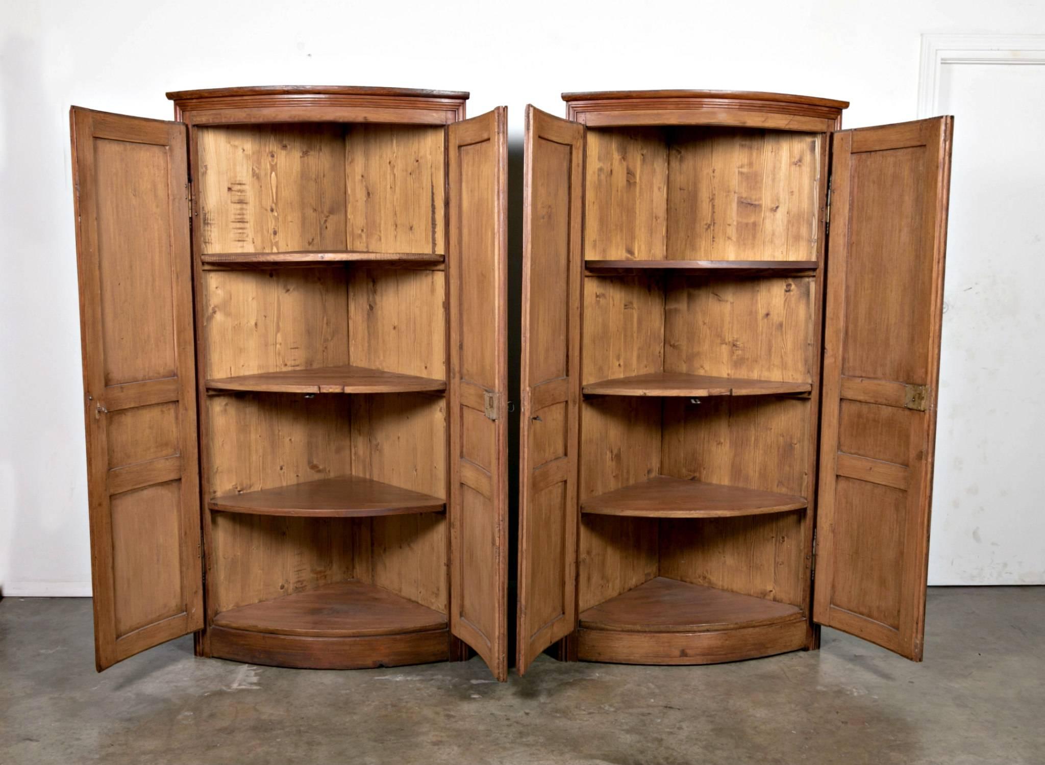 A wonderful pair of pine corner cabinets crafted from antique French boiseries panels. Ample shelving to the interior.

Dimensions:
Height 71 inches
Width 38 inches
Depth 24 inches
Corner 26 inches.