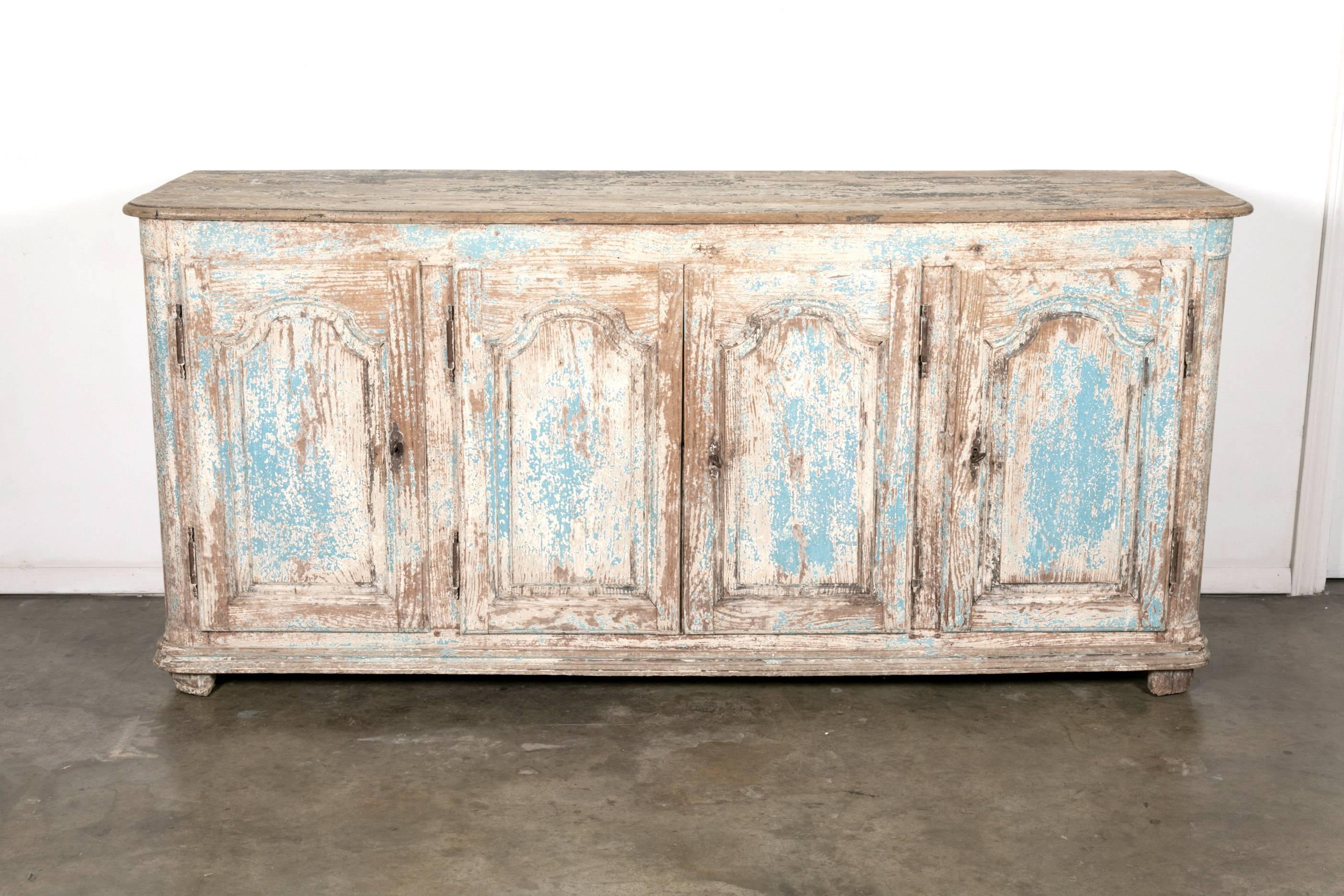 A wonderful 18th century French enfilade buffet in painted wood from the South of France near Avignon. The four paneled doors open to reveal an interior shelf and spacious storage. Beautiful painted finish and patina. Will add charm and character to