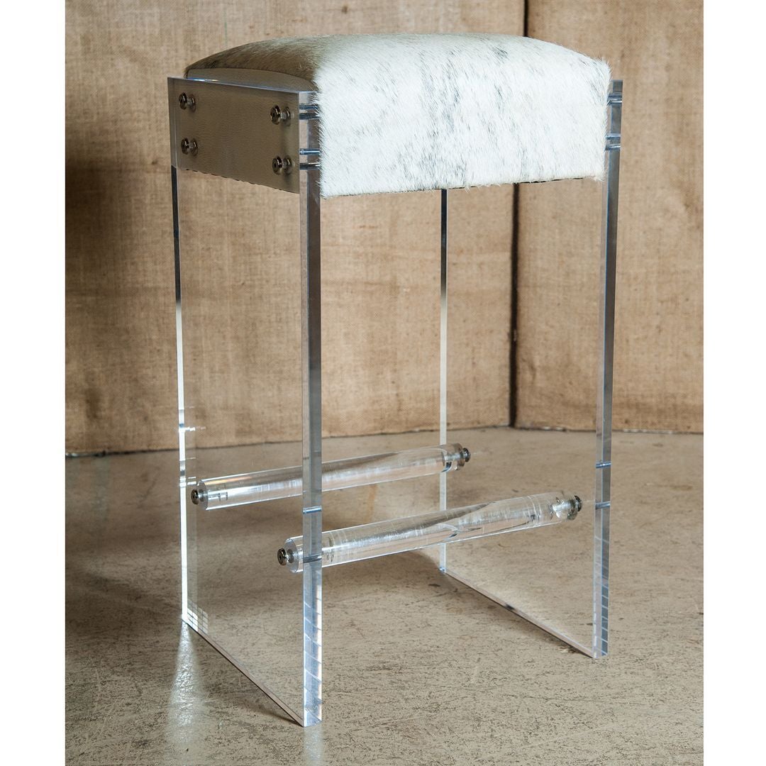 Maurice Lucite bar stool. Add style and a touch of Hollywood Glam to your decor. Modern acrylic frame fastens to cowhide seat featuring cream faux leather sides with polished stainless steel fasteners. Bar stool comes with two clear acrylic