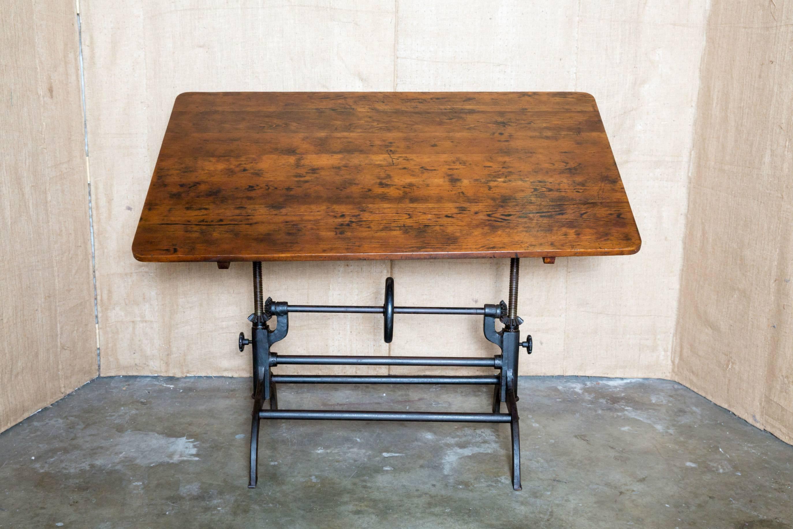 Vintage Hamilton drafting table with adjustable height and tilt, cast iron legs and hardware, articulating arm, and original pine top. Tilts in both directions for a very versatile work space.
Dimensions:
HEIGHT:	33.5