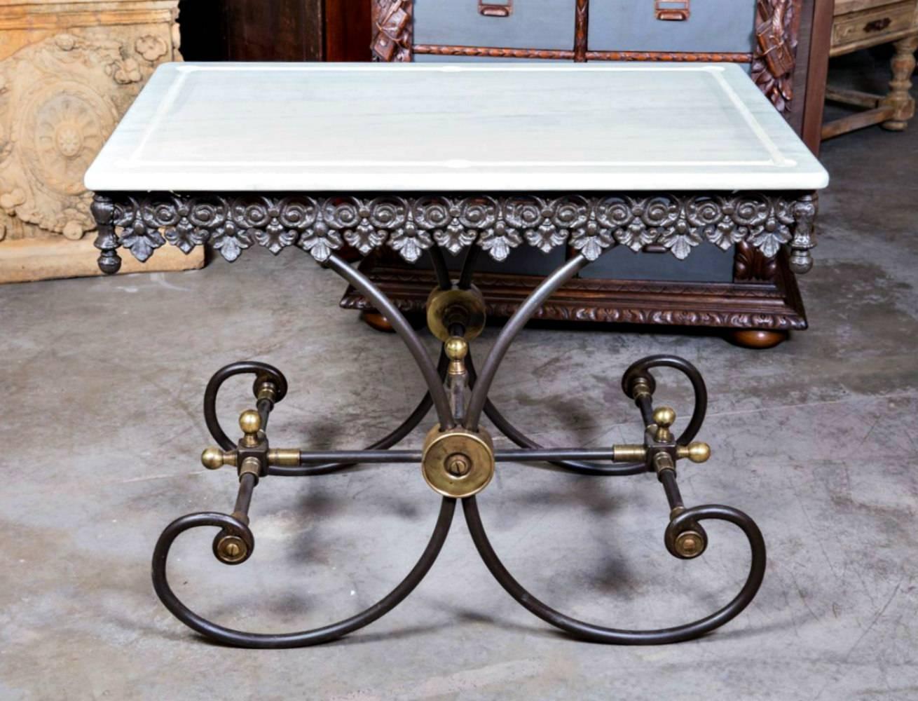 Small French pastry or butcher's table with a cast and wrought iron base featuring decorative brass elements and a marble top. Often referred to as pastry tables, the primary purpose of these beautiful tables was for use in a butcher shop. Some were