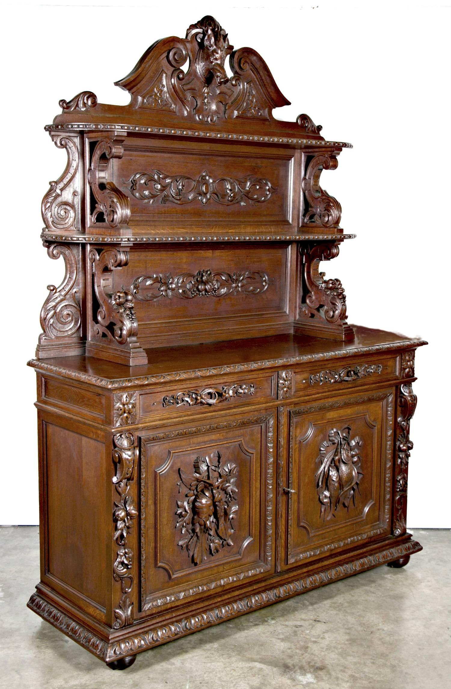 A stunning example of Rennaisance style furniture, this mid-19th century French St. Hubert Buffet de Chasse or hunting vaisselier is richly and intricately carved with motifs of animals of the hunt, fruit, nuts and vines. Buffet de chasse were found