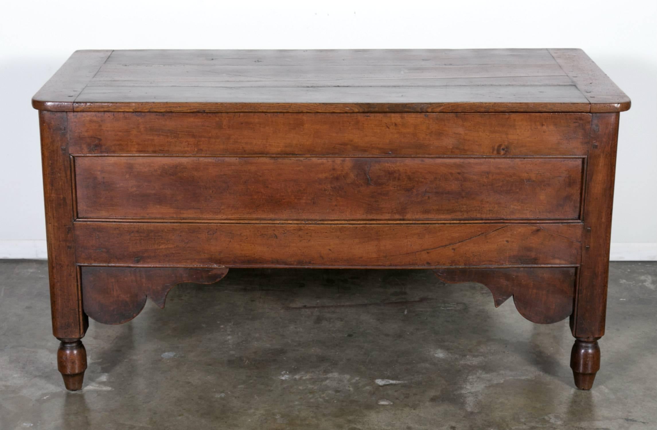 Charming antique country French solid walnut Louis XVI maie or grain trunk with hand-forged iron hinges and top that lifts, raised on toupie feet. Great interior storage.