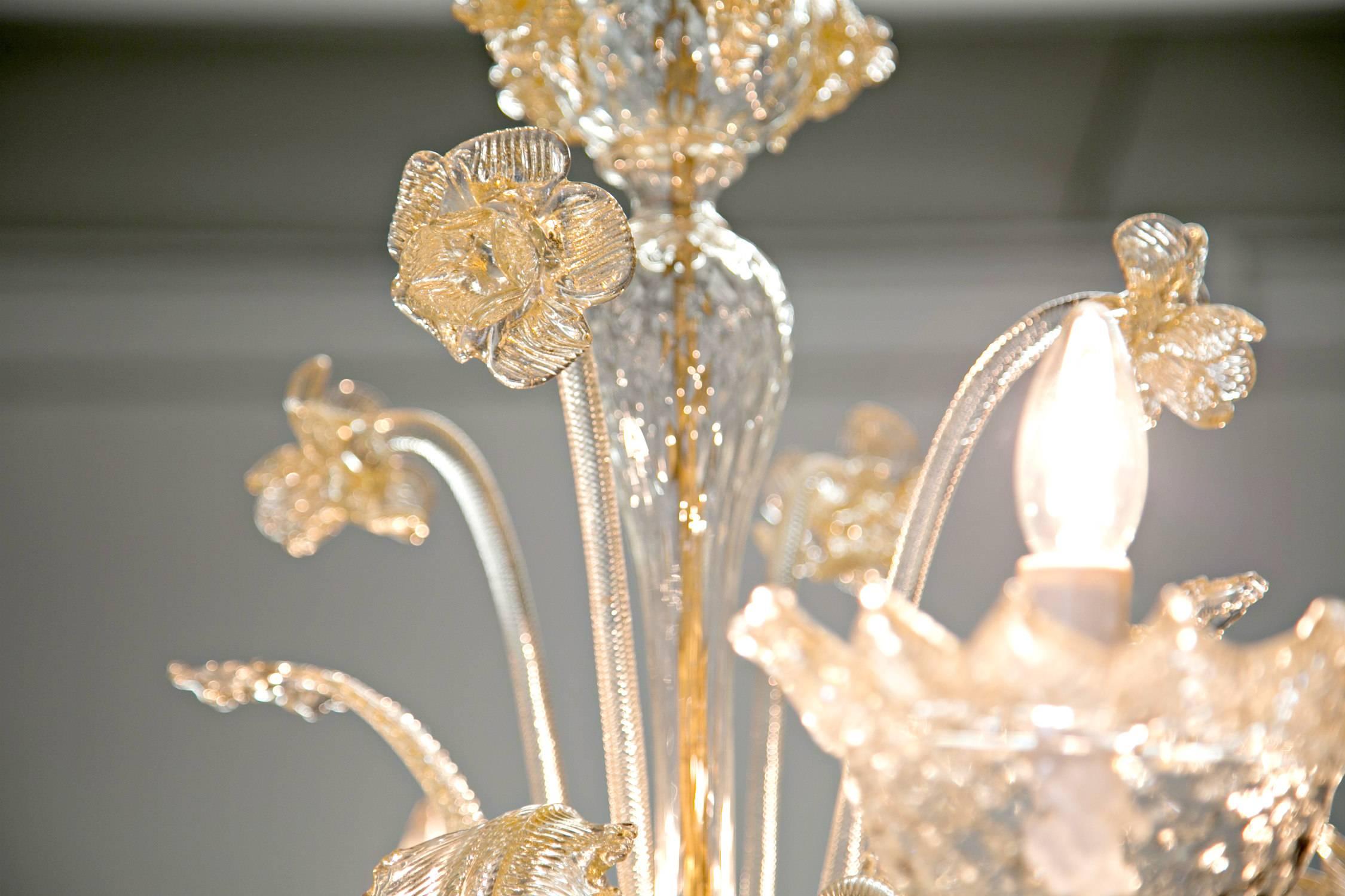 Vintage gold dust venetian glass daffodil chandelier, complete with all original handblown leaf and daffodil decoration. This circa 1950s Murano glass chandelier has four curved glass arms with candle style lights. Glass color is called gold dust