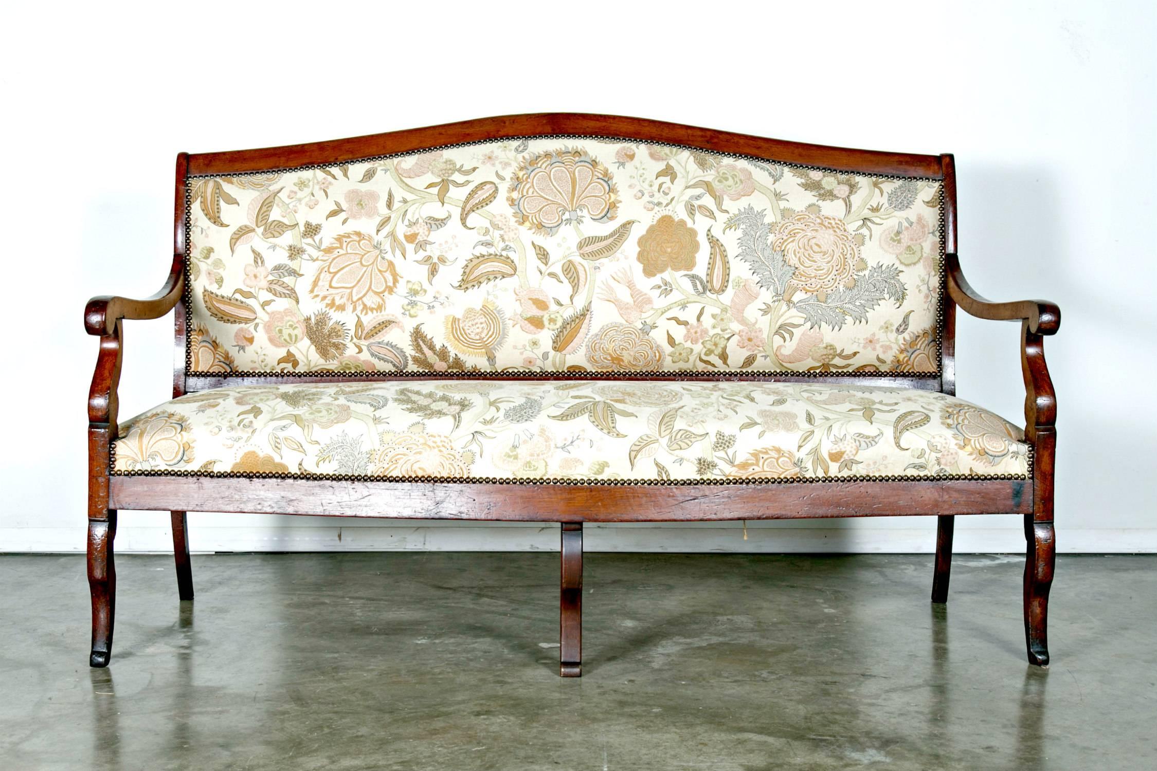 19th century French Restauration period sofa of solid, polished walnut having scrolled arms and upholstered back with show-wood. Very sturdy and comfortable seating.

Dimensions:
back height 40.25 inches,
seat height 18 inches,
arm height 26