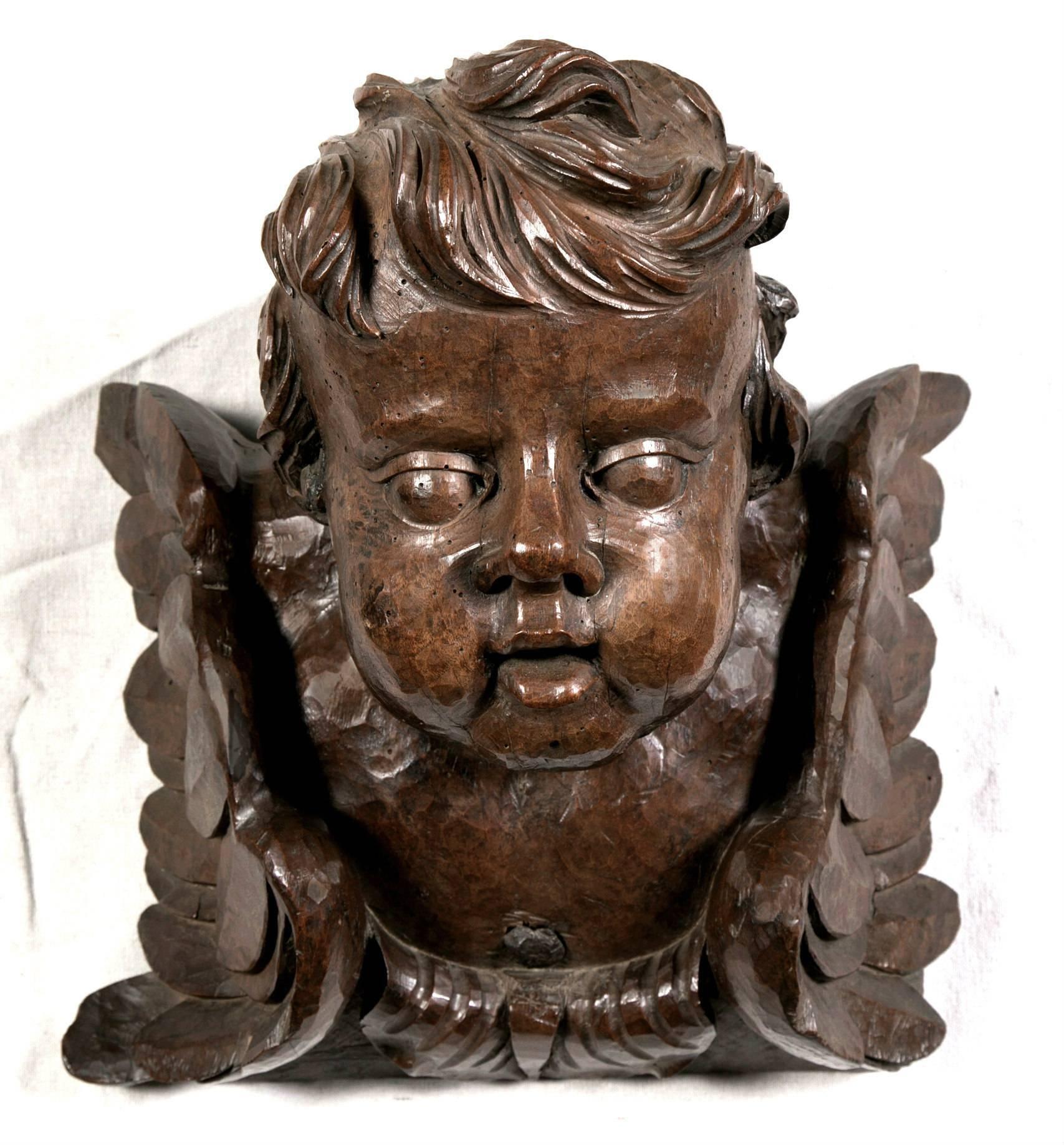 A sensational set of four intricately carved 18th century Baroque Italian cherubim. Hand-carved by a master artisan, this set of solid walnut cherubs came from a small church near Florence. All the elegance and high style of the Baroque period are