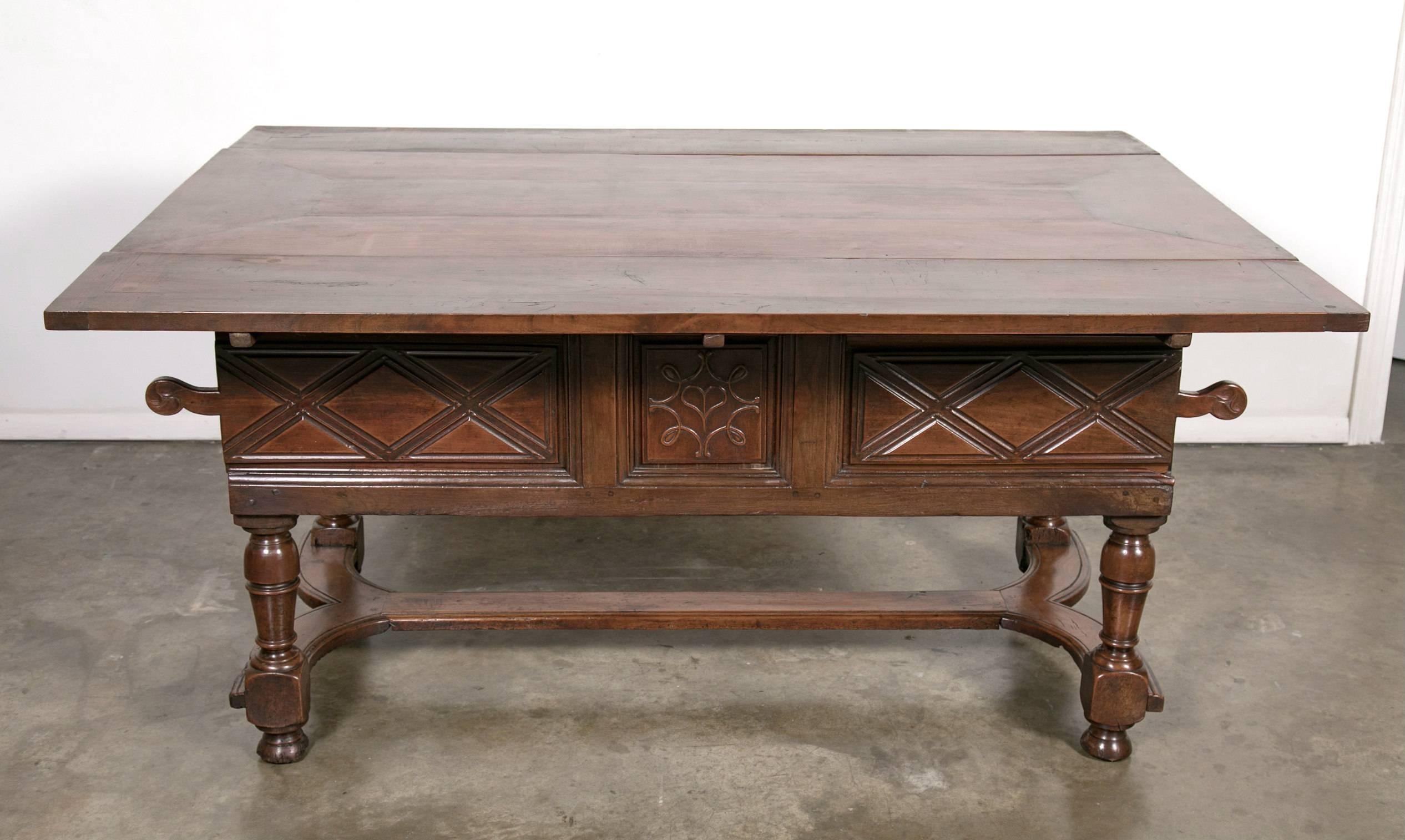 An 18th century solid cherry draw leaf work or pantry table handmade by talented artisans near Mont Saint Michel, an island commune in Normandy. This Country French draw leaf table was often found in small farm houses where it doubled as a work