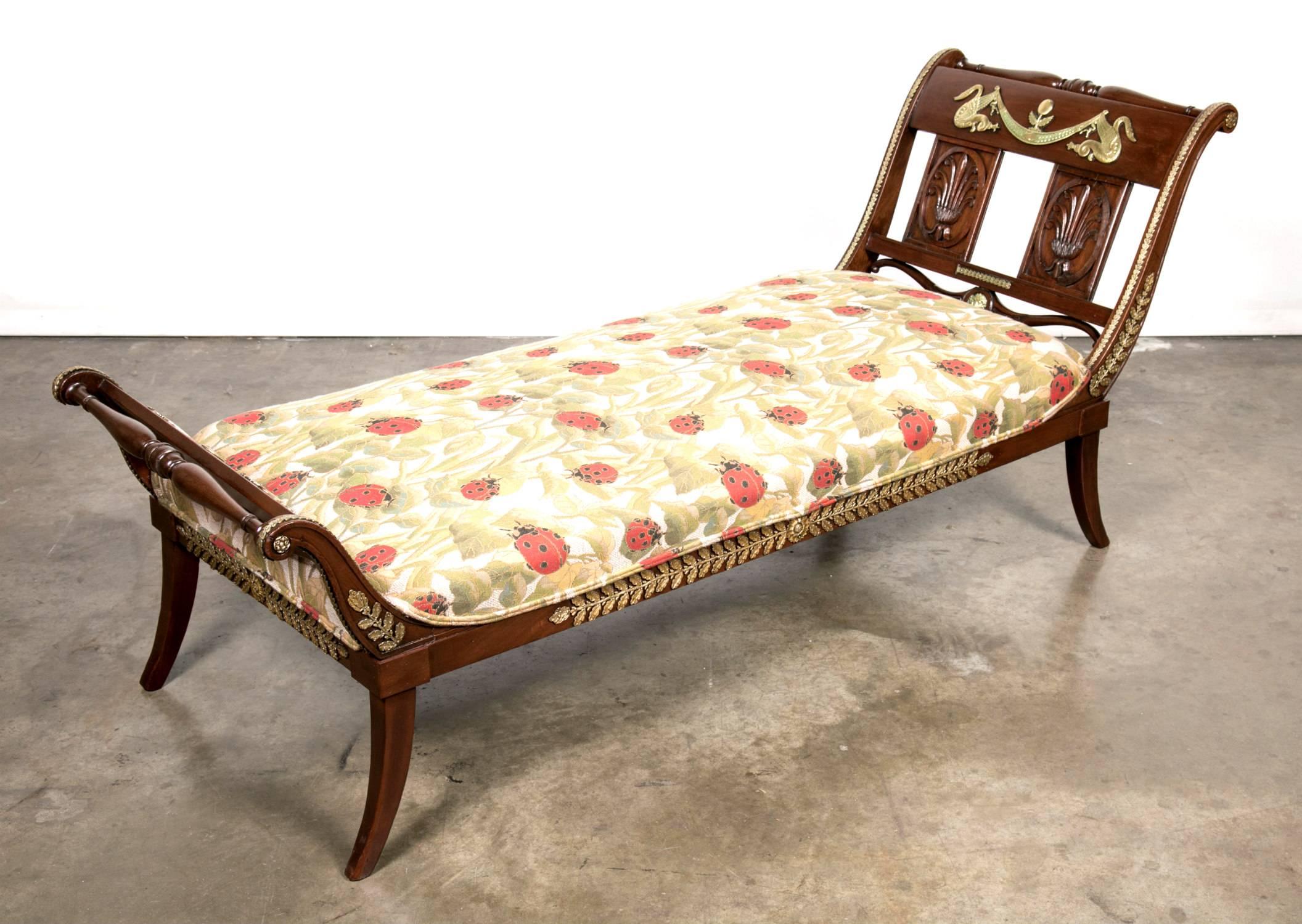 Exquisite early 19th century French Empire period mahogany lit de repos or chaise longue with ornate bronze mounted classical decoration to the sides, back, and foot. A fine showcase of craftsmanship, fully finished on all sides, with a wonderful