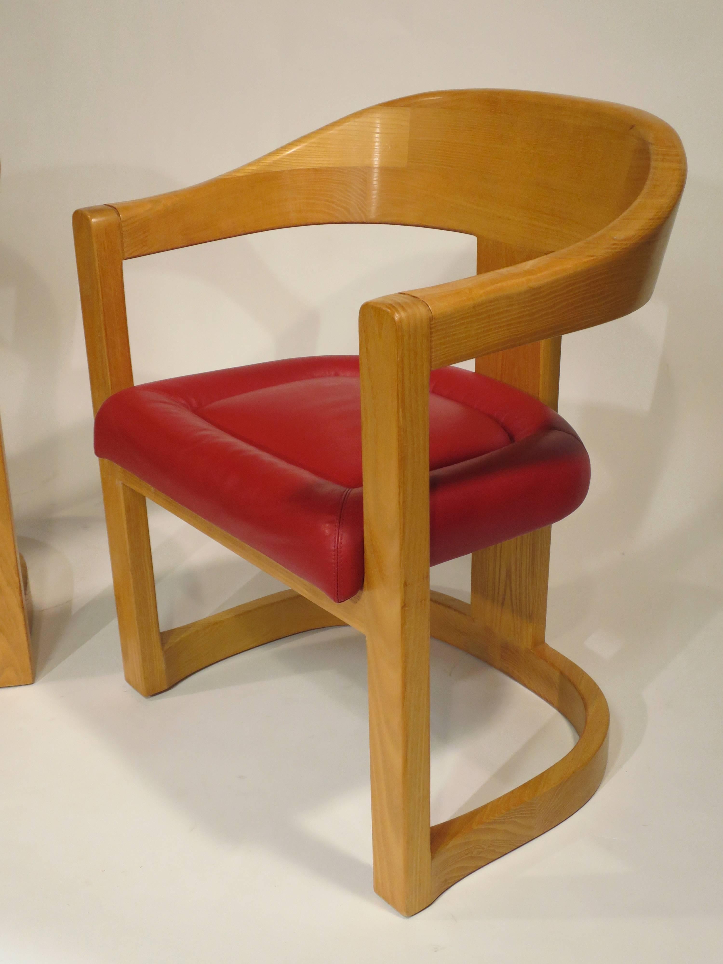 Pair of 'Onassis' chairs by Karl Springer. Solid oak construction with original red leather seats, circa late 1970s.