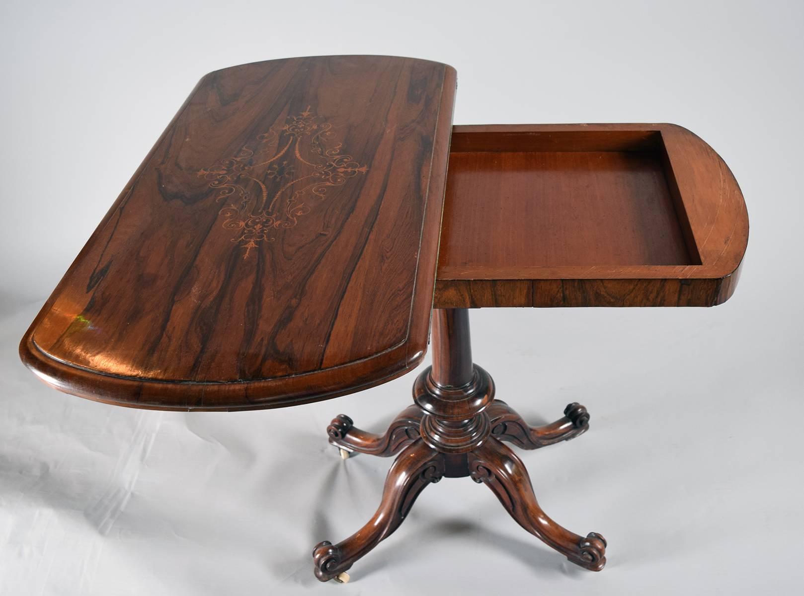 An inlaid rosewood swivel top card table on a finely carved quadruped base, circa 1820. 
     

Provenance: Roundwood Manor, Hunting Valley, Ohio.