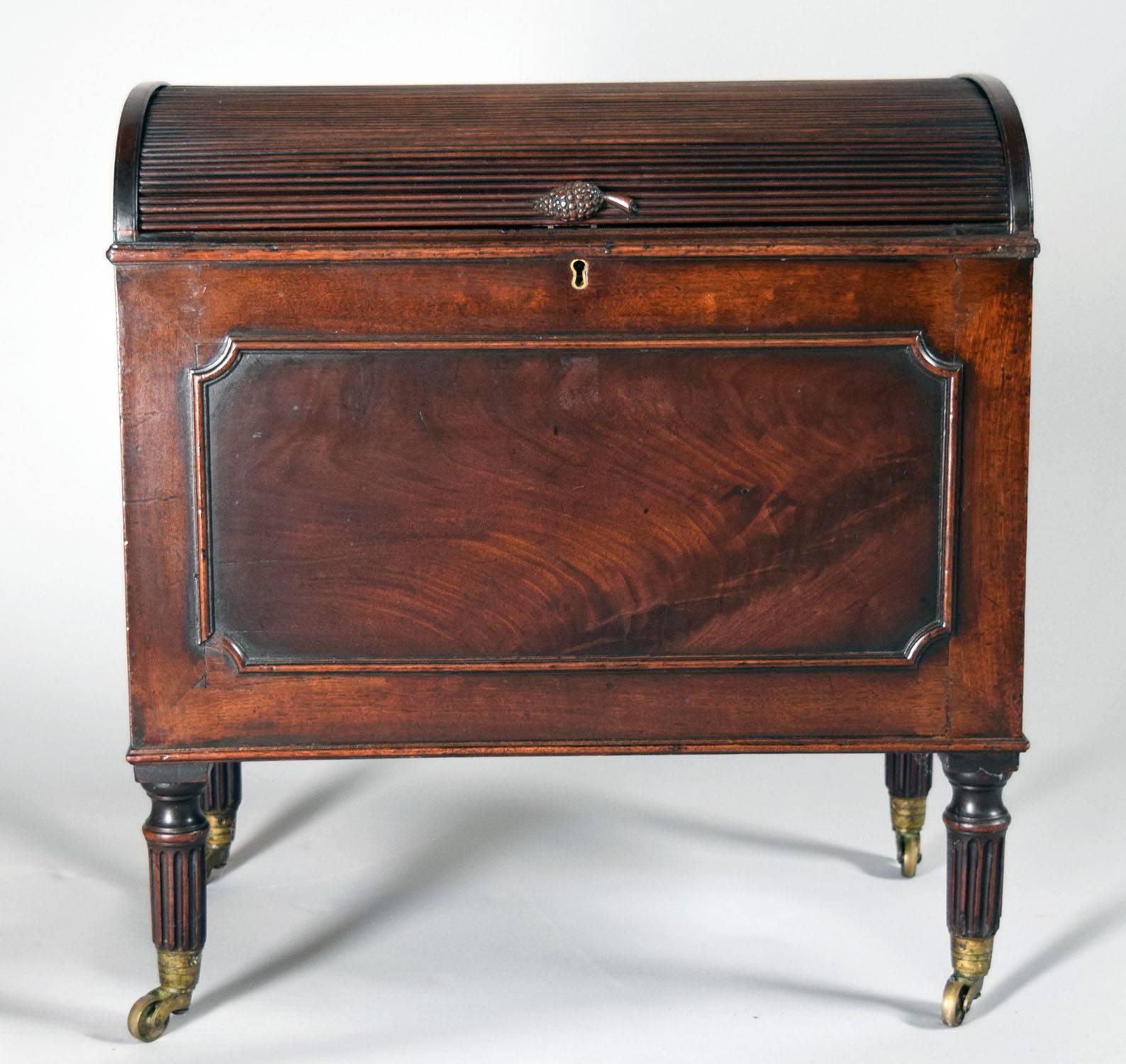 Mahogany domed top form with turned reeded legs on casters and handsomely adorned with dramatic mahogany inset veneer, circa 1790.

Provenance: Roundwood Manor, Hunting Valley, Ohio.